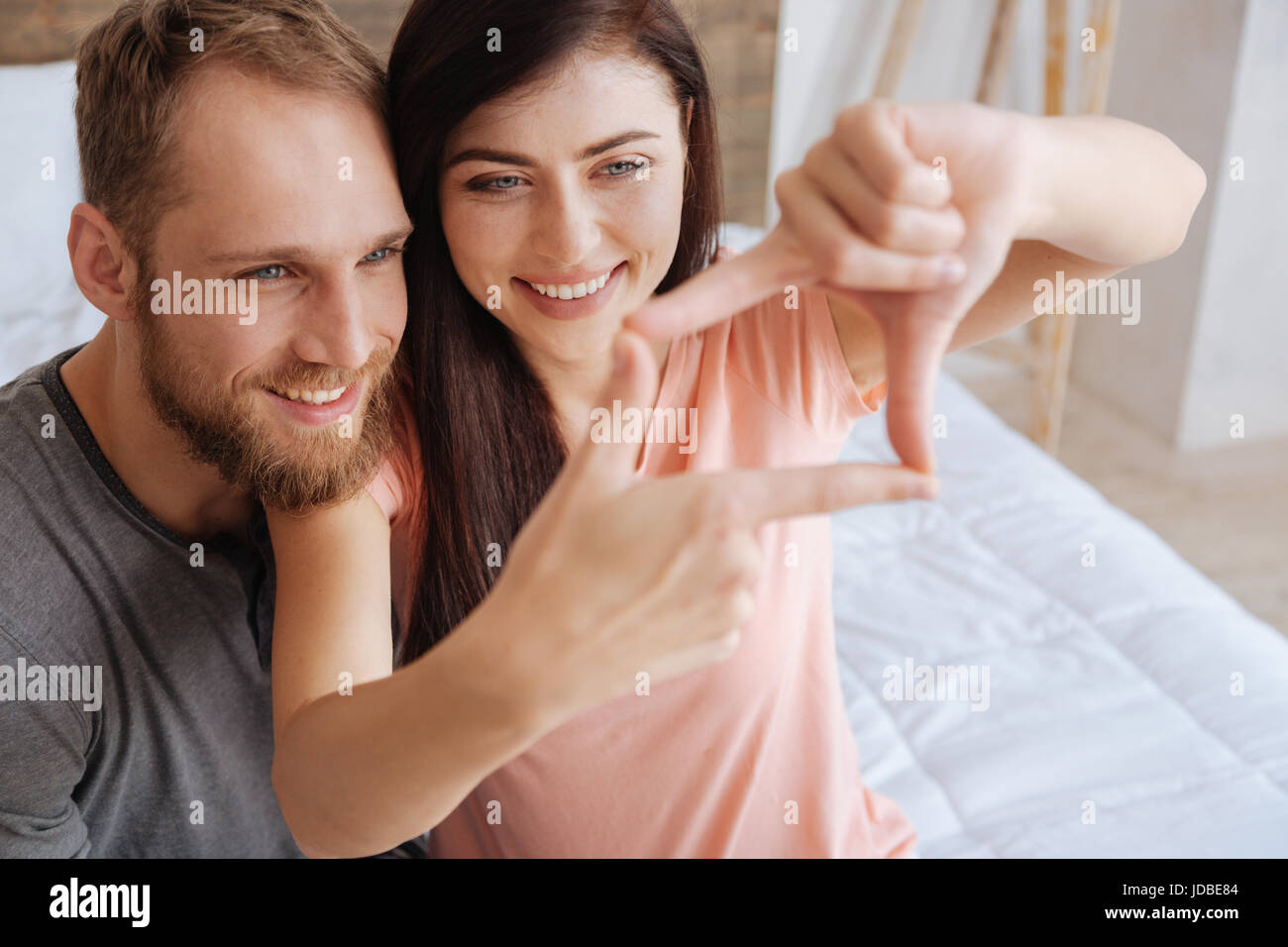 Porträt des tausendjährigen paar Rahmung Gesichter mit Händen Stockfoto