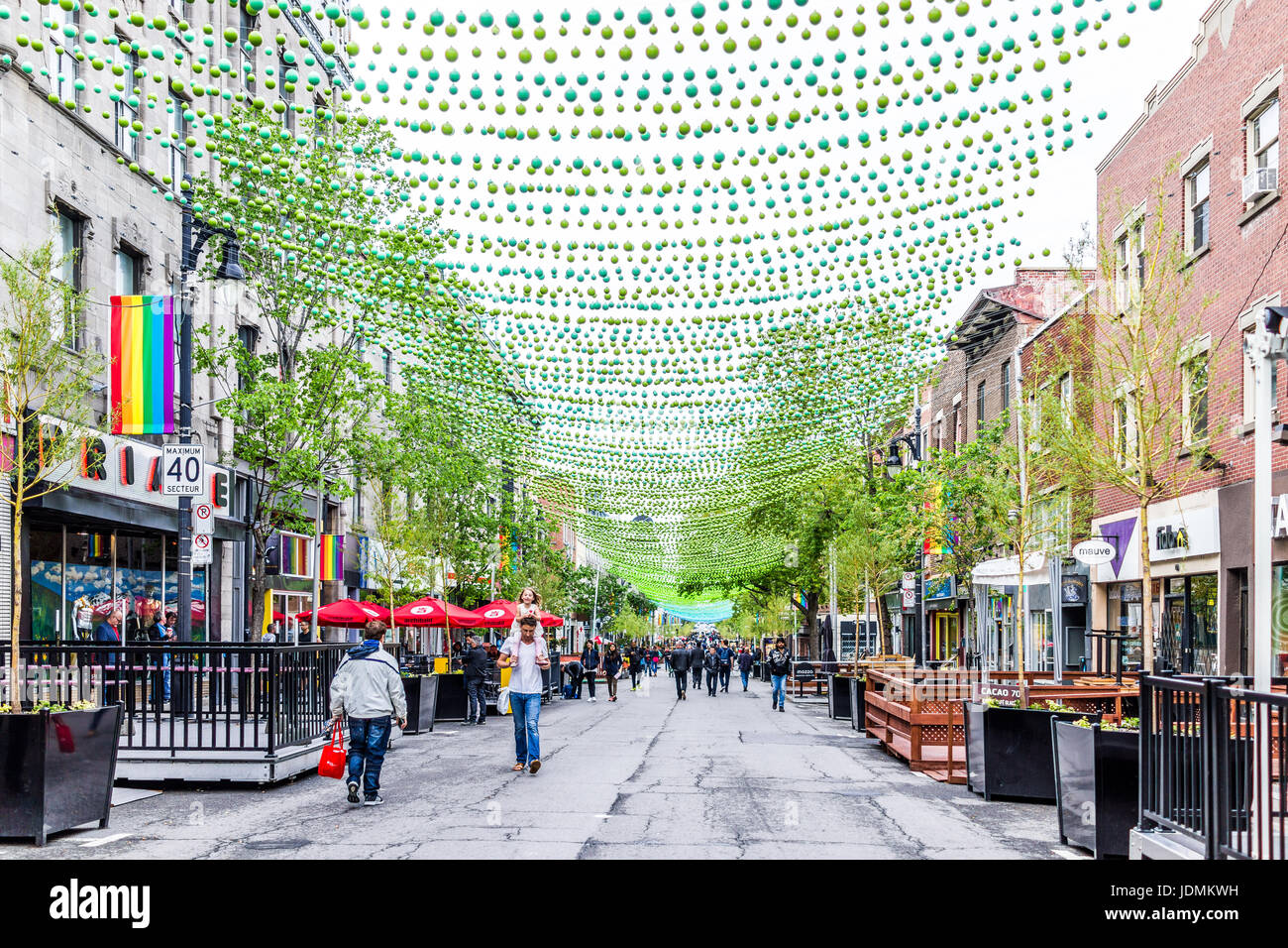 Montreal, Kanada - 26. Mai 2017: Menschen zu Fuß auf Sainte Catherine Street in Montreal Gay Village in Quebec Region mit hängenden Dekorationen Stockfoto