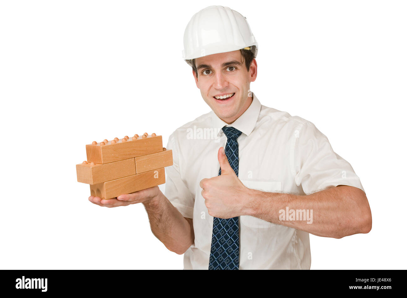 Seitliche Oberkörper-Aufnahme Eines Jungen Mannes Im Weißen Hemd Und Donnersberger Helm Holzkötzer Hochhaltend Und deutsche-Hoch-Geste Vor Weissen Hintergrund Freudig in Die Kamera blickend Stockfoto