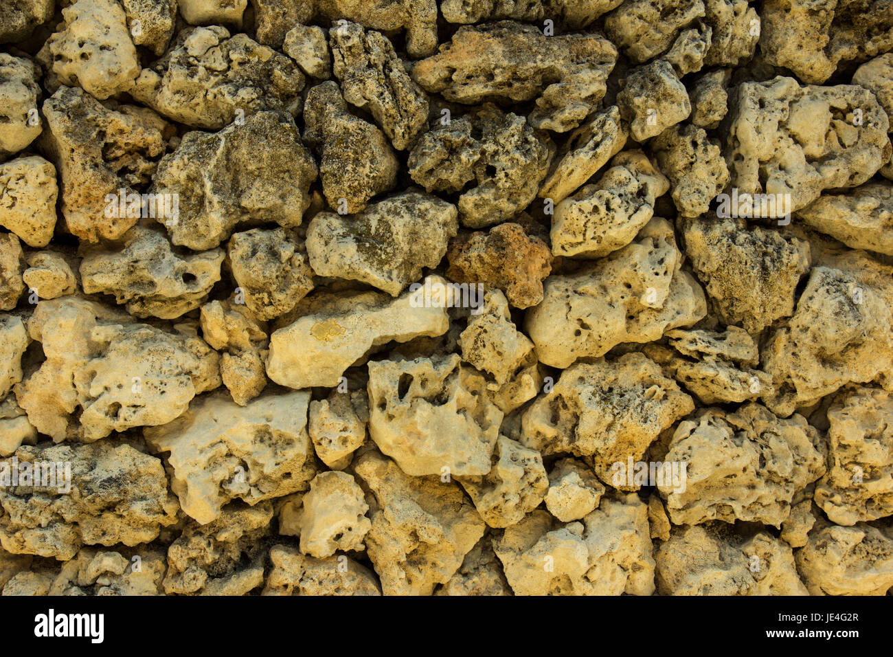Alten gelbe Stein Wand Textur Hintergrund closeup Stockfoto