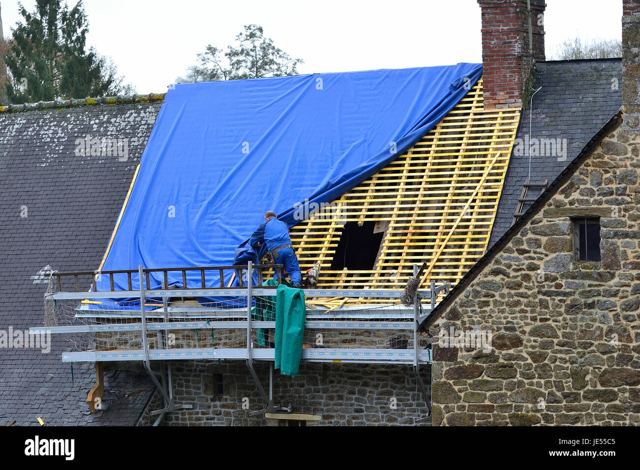 Reparatur eines Daches eines alten Hauses in einem französischen Dorf (Mayenne, Land der Loire, Frankreich). Stockfoto
