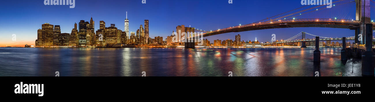 Panoramablick auf Lower Manhattan Financial District Wolkenkratzer in der Dämmerung mit der Brooklyn Bridge und dem East River. New York City Stockfoto