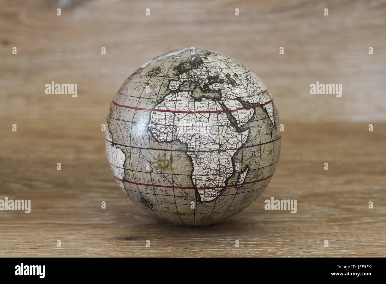 Eine Kugel oder Globus der Welt, die einen Oldtimer und alte altmodischen Look auf einem hölzernen Hintergrund hat. Stockfoto