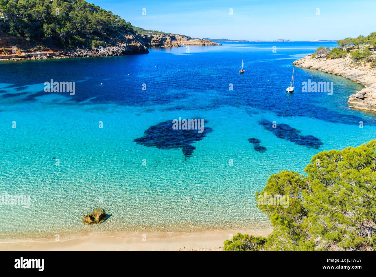 Blick auf den schönen Strand in Cala Salada berühmt für seine Azure kristallklares Meerwasser, Insel Ibiza, Spanien Stockfoto