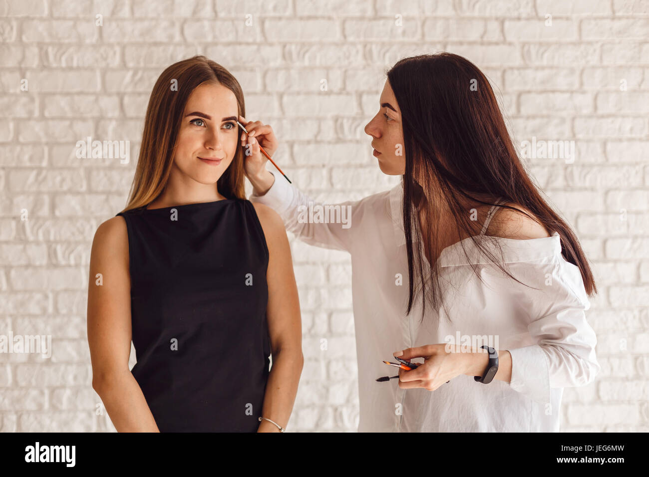 Frau-Client während der Korrekturverfahren und Malerei Augenbrauen Stockfoto