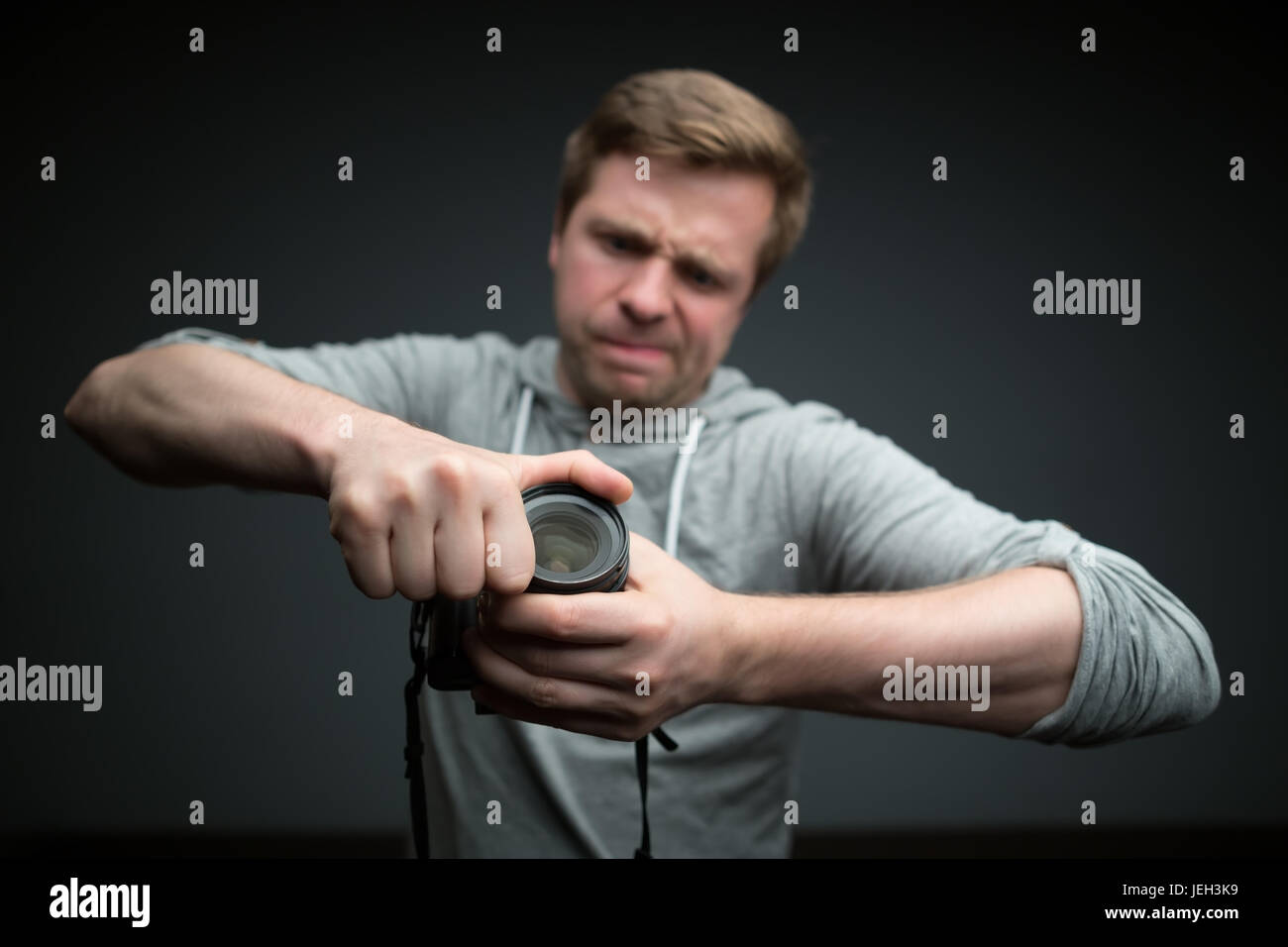 Gut aussehend Fotograf mit Kamera im Fotostudio Stockfoto
