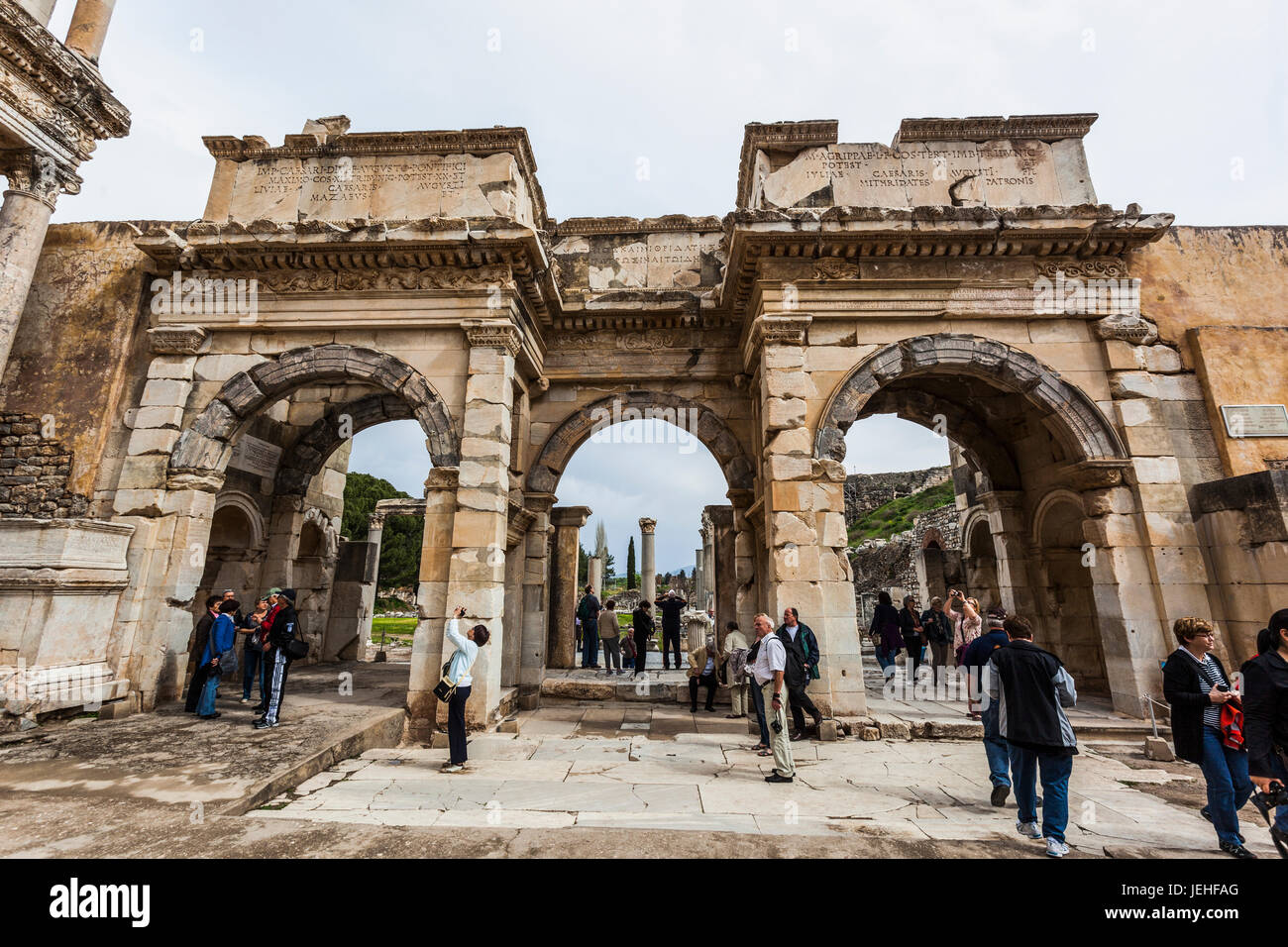 Touristen zu Fuß unter den Ruinen der Celsus-Bibliothek; Ephesus, Izmir, Türkei Stockfoto
