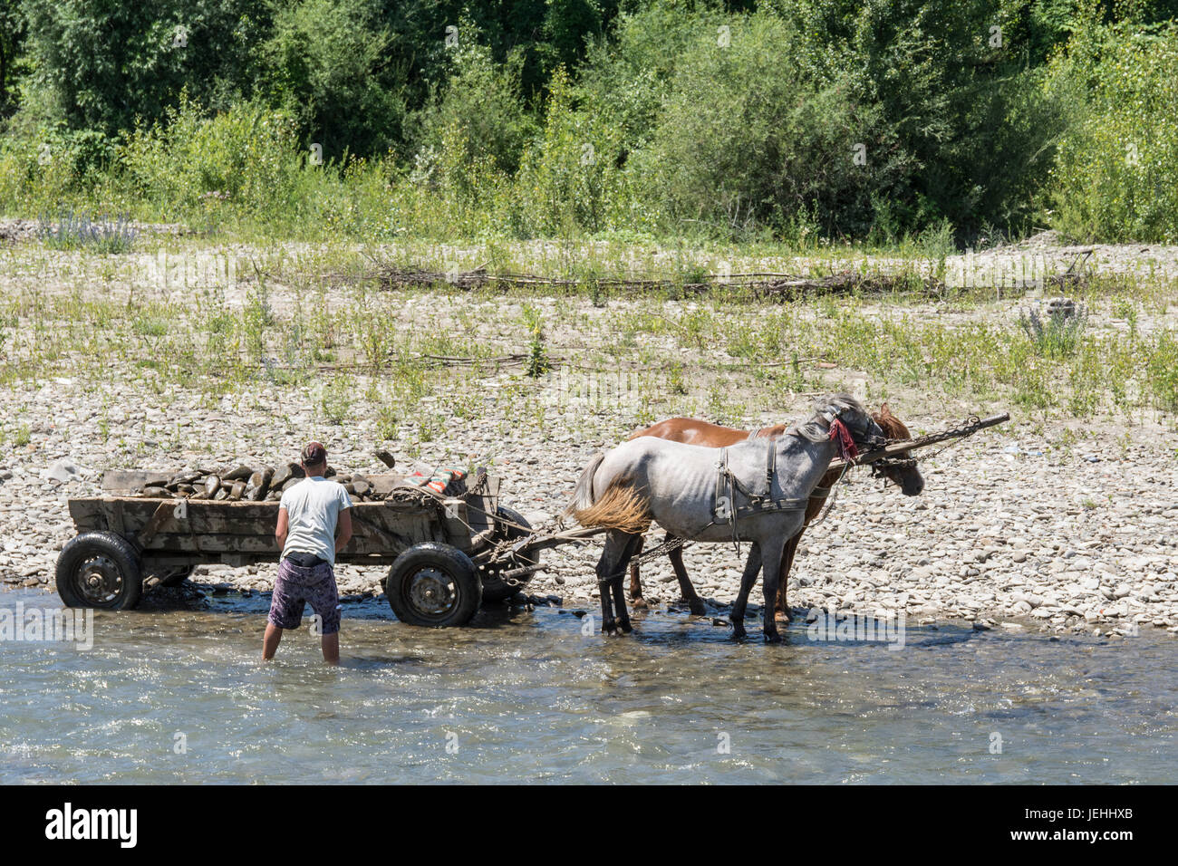 Sammlung von Steinen mit einem Pferd gezogenen Wagen in der Theiß in der Ukraine Stockfoto