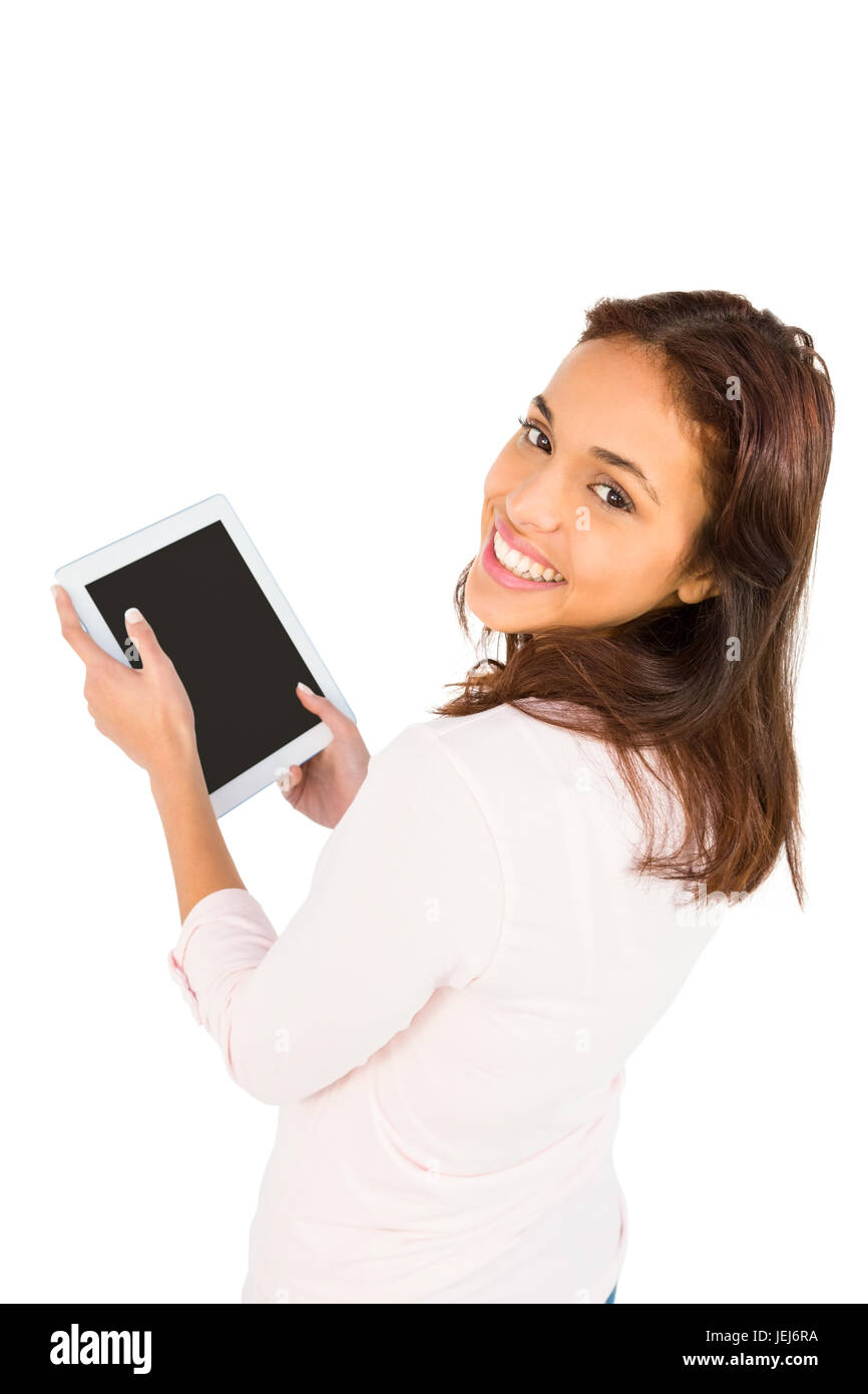 Lächelnde lässige Frau mit ihrem Tablet-pc Stockfoto