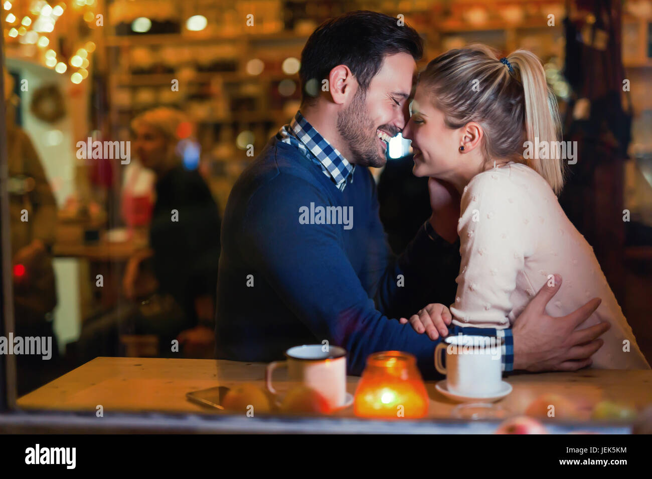 Attraktive Brautpaar küssen in bar mit Datum Stockfoto