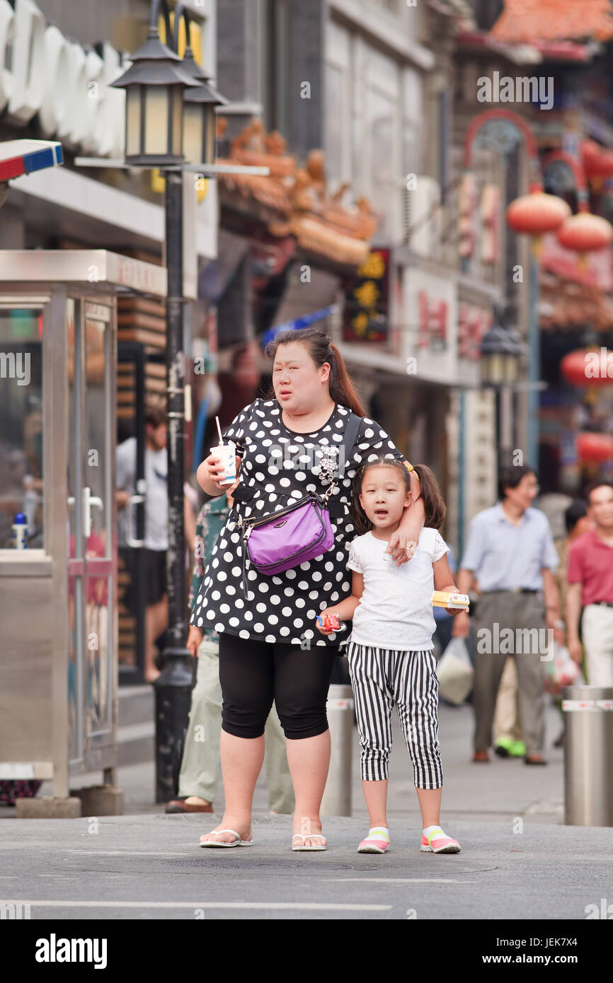 PEKING, 9. JUNI 2015. Übergewichtige Frau mit einem Kind. Chinas Fettleibigkeit ist in den letzten drei Jahrzehnten in die Höhe geschossen und hat 46 Millionen Fettleibigkeit verursacht. Stockfoto