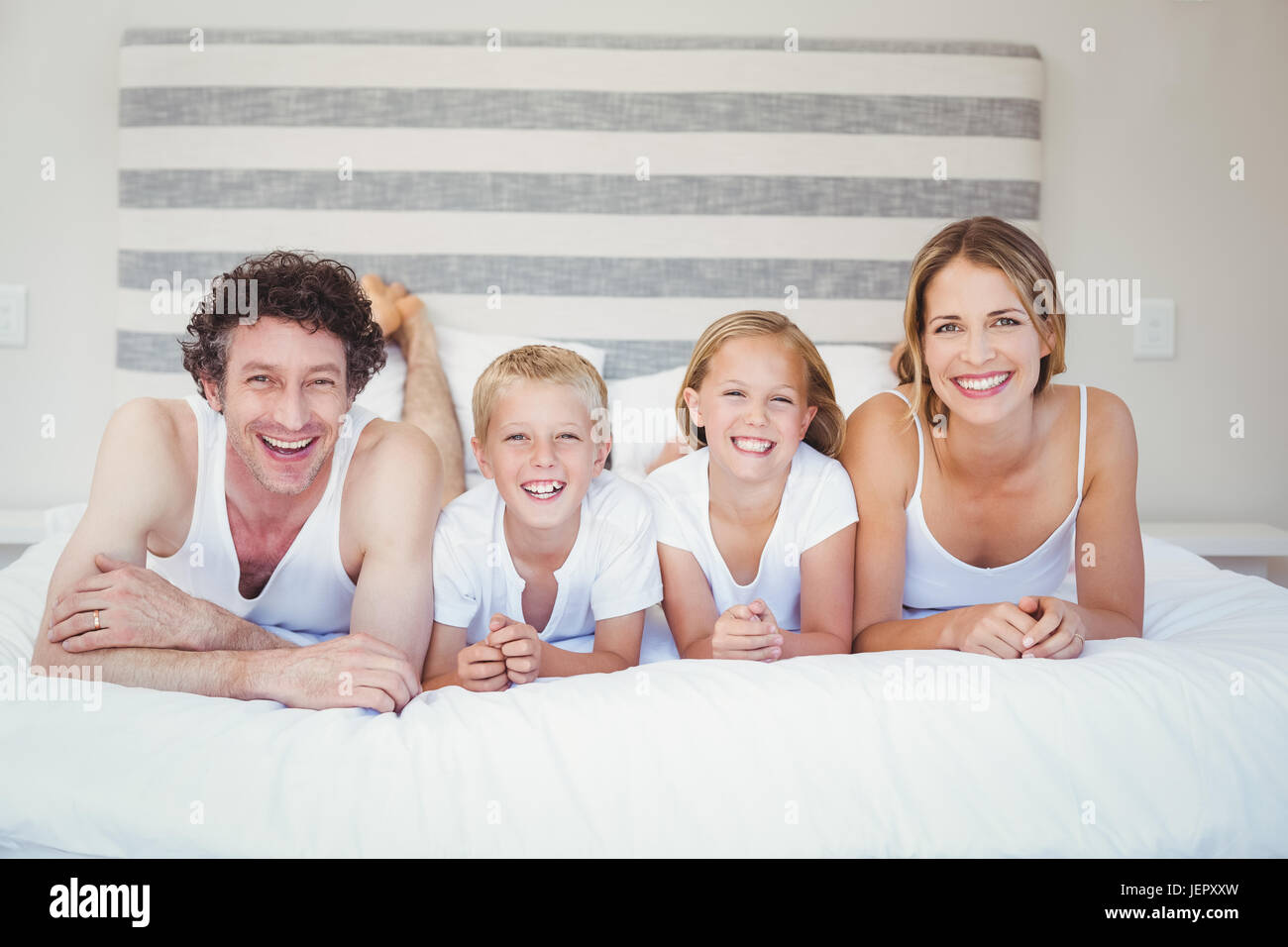 Porträt der glückliche Familie ruht auf Bett Stockfoto