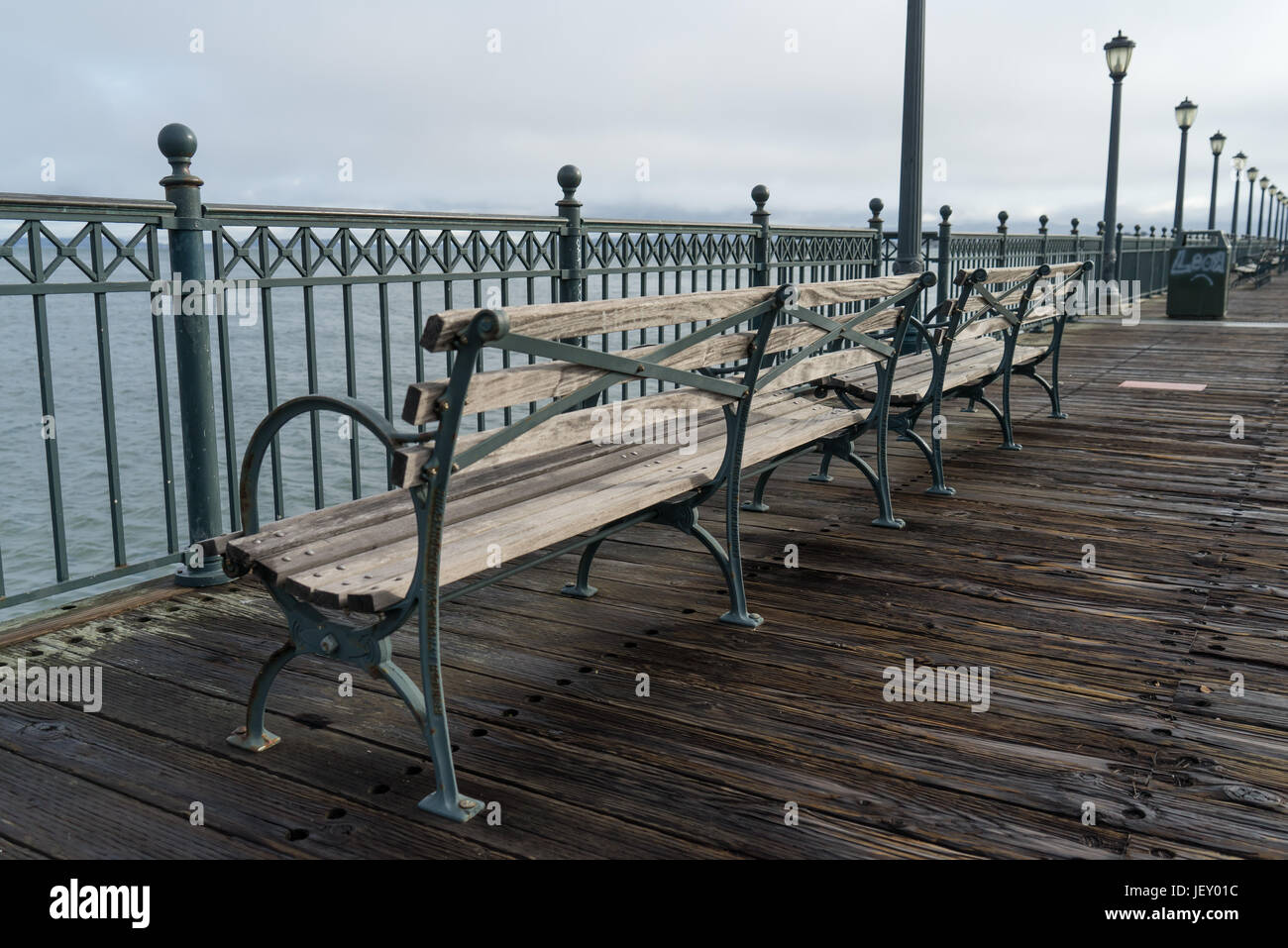 Parkbänke entlang einer Holzmole in San Francisco Stockfoto