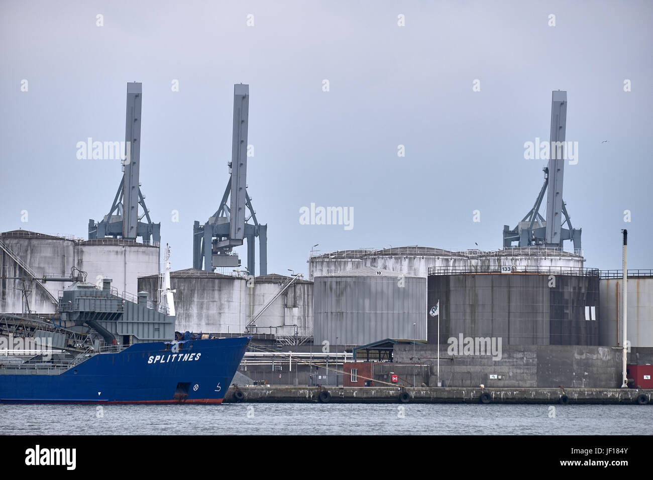 AARHUS (Dänemark)-5. Juni 2016: Portalkrane und Silos auf den Hafen von Aarhus, wo ein blaues Schiff vor Anker liegt Stockfoto