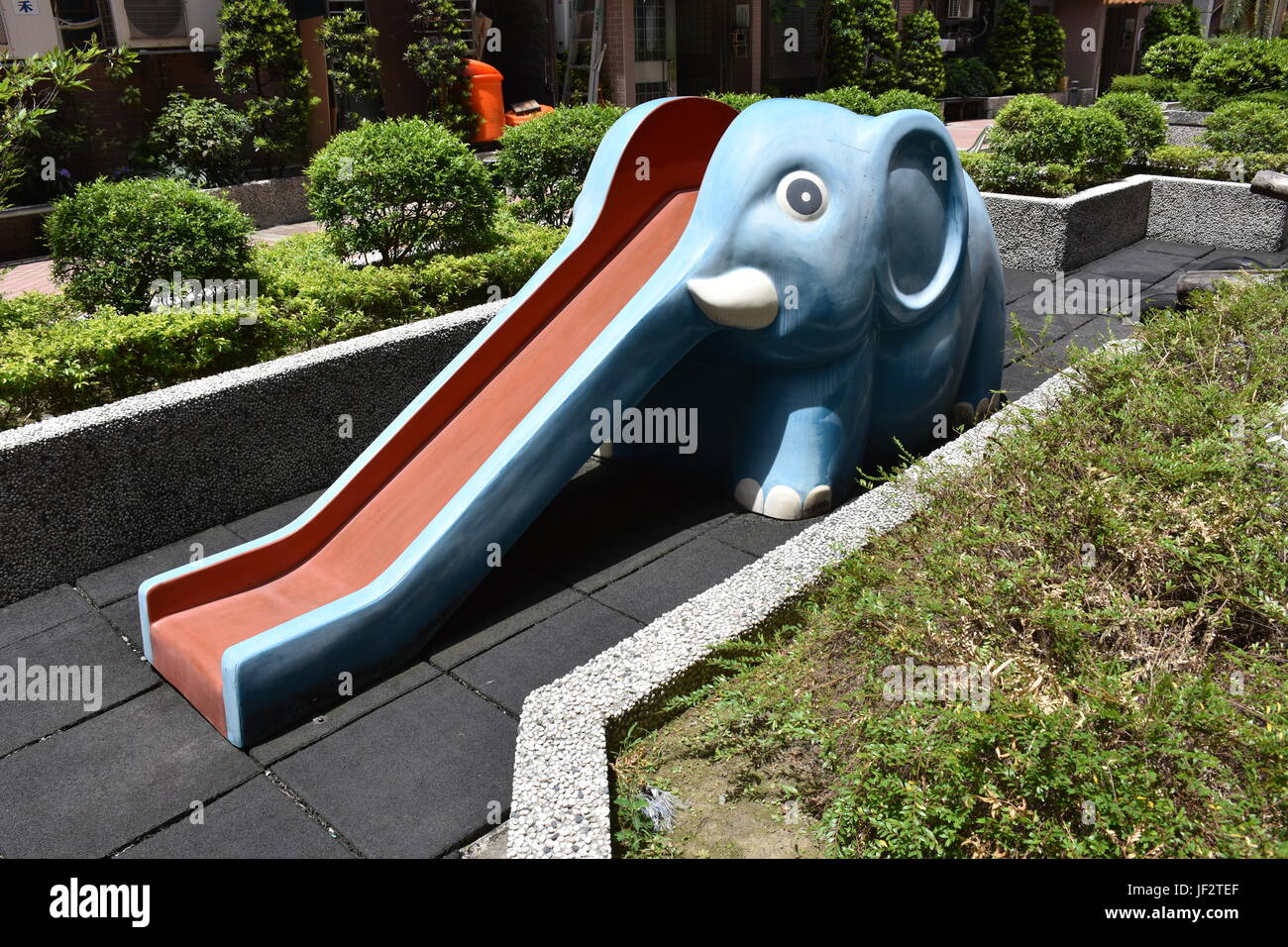 Ein Spaß blaue Elefant mit weißen Stoßzähne und einen langen Rüssel, der  die Rutsche im Garten Spielplatz-Community-Bereich ist Stockfotografie -  Alamy