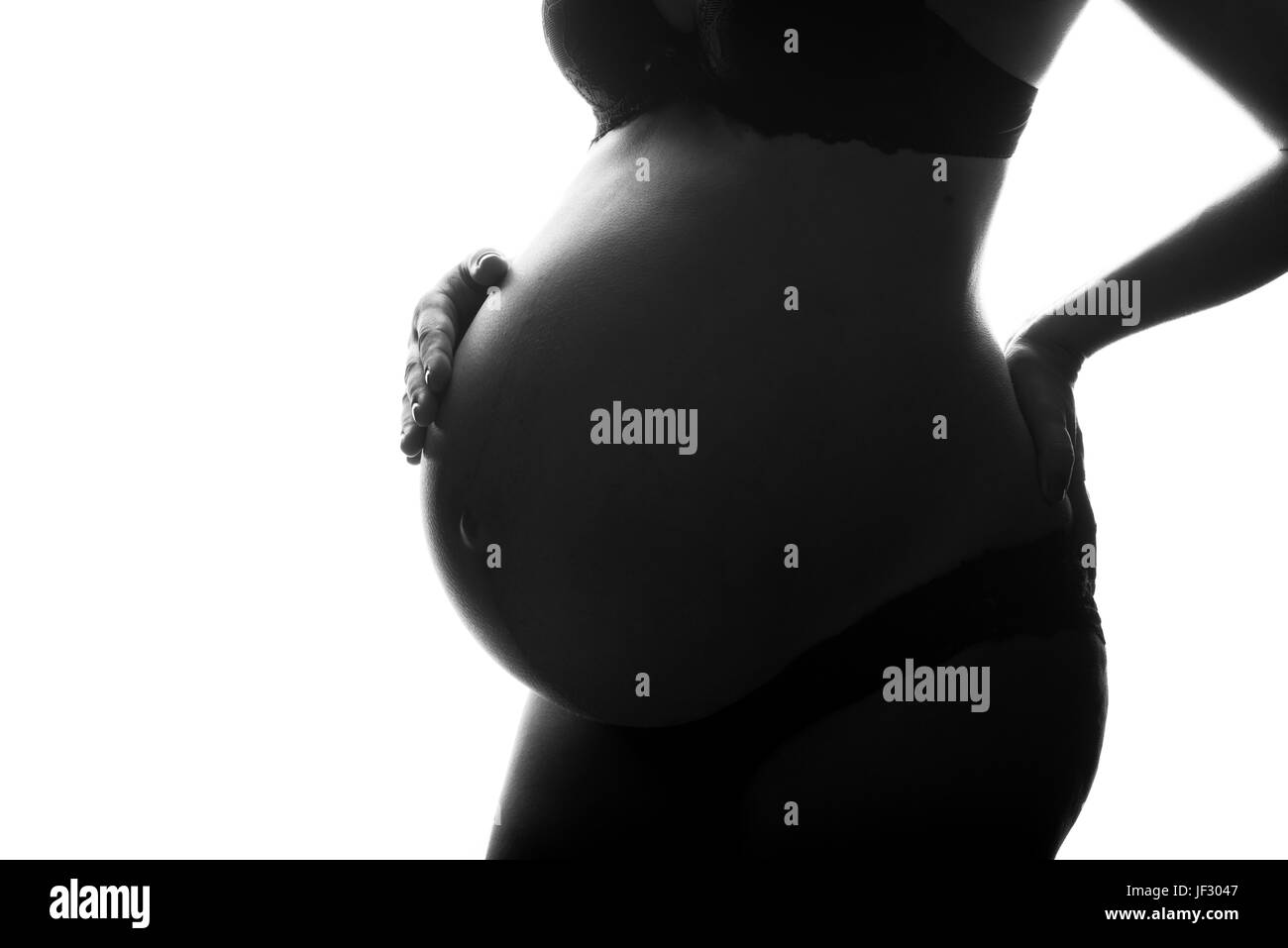 Silhouette der schwangeren Frau auf einem weißen Hintergrund. Stockfoto