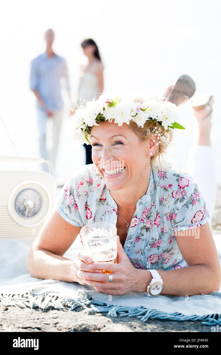 Lächelnde Frau tragen Blumen Kranz Stockfoto
