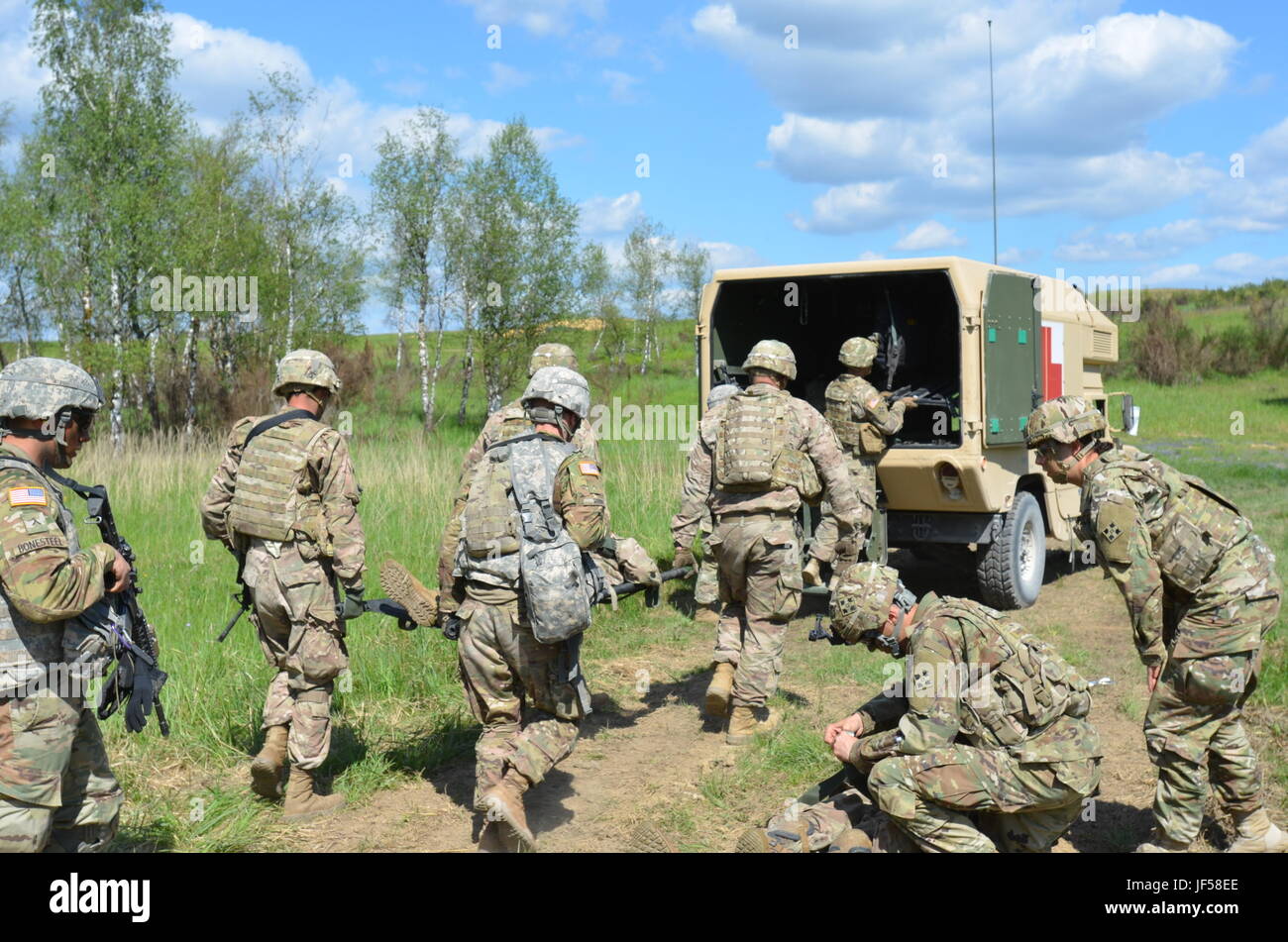 US-Armee Soldaten des 2. Bataillons, 12. Infanterie-Regiment, 2nd Infantry Brigade Combat Team, 4. US-Infanteriedivision prep zwei mock "Opfer" für den Transport im Rahmen einer Bataillon scharfer Munition Übung auf Grafewoehr Trainingsbereich, Deutschland am 26. Mai 2017. Die Übung war das ultimative Beispiel für Teamwork, als viele Züge zusammen gearbeitet, um Schlachtfeld Zusammenhalt und Effektivität, mit der zusätzlichen Gefahr von live runden fliegen overhead. (Foto von Pvt. Nicholas Vidro, 7. Mobile Public Affairs-Abteilung) Stockfoto