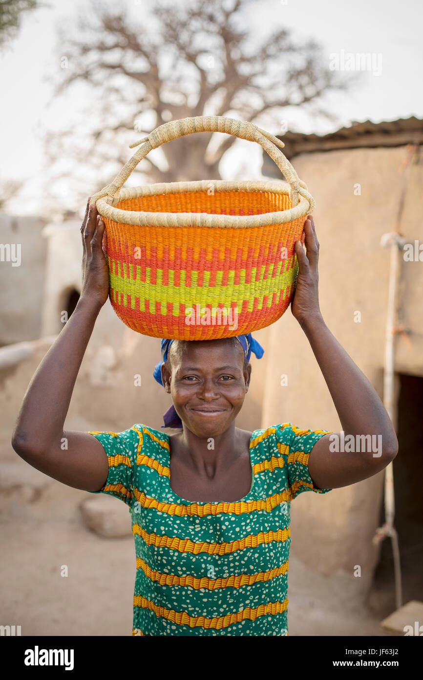 Eine Frau hält einen traditionellen Stroh Korb Upper East Region, Ghana. Stockfoto