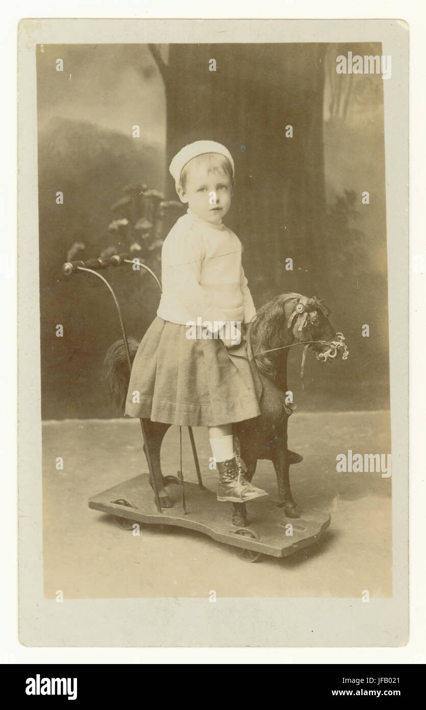 1920er Studio-Postkarte von jungen Mädchen auf Spielzeug Pferd, Mansfield, Nottinghamshire, England, Großbritannien Stockfoto