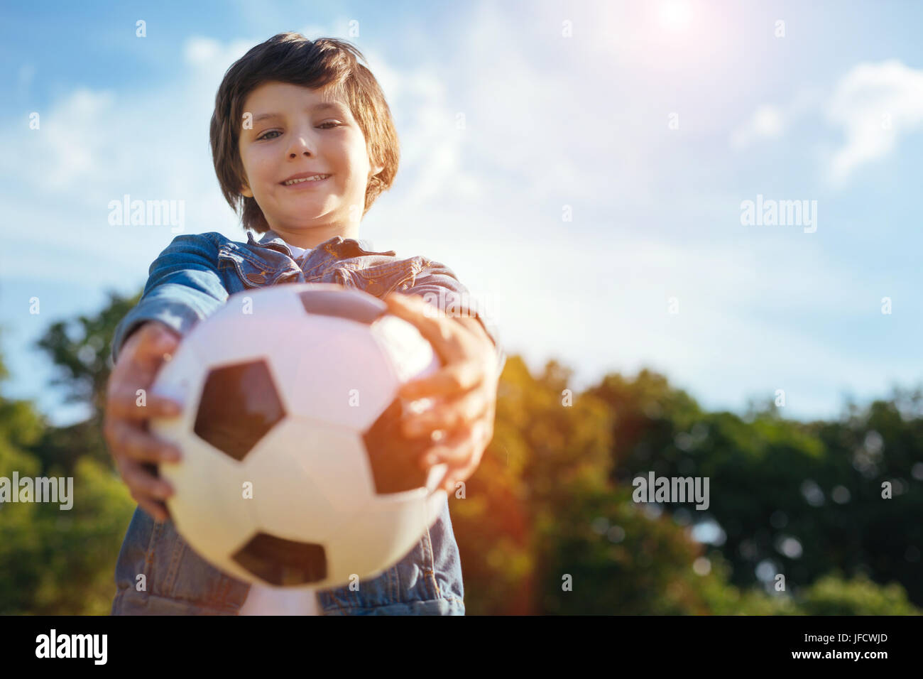 Hiermit können spielen. Ehrgeizige easy-Going talentierte Kind Übergabe einen Ball und bittet, mit ihm zu spielen, während die Ausgaben ein aktives Wochenende im freien Stockfoto