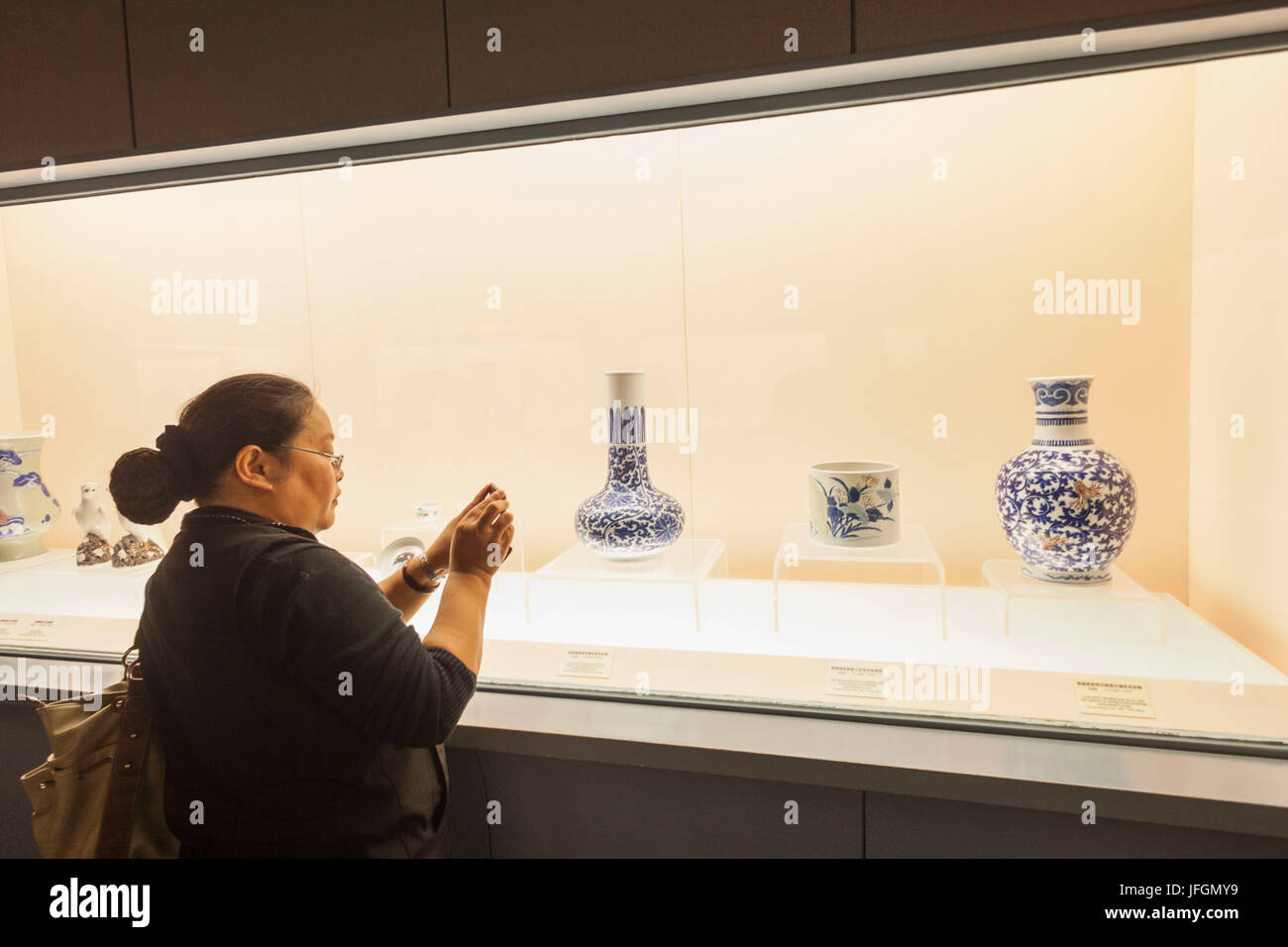 China, Shanghai, Shanghai Museum, Mädchen Foto von antiker Keramik Display Stockfoto