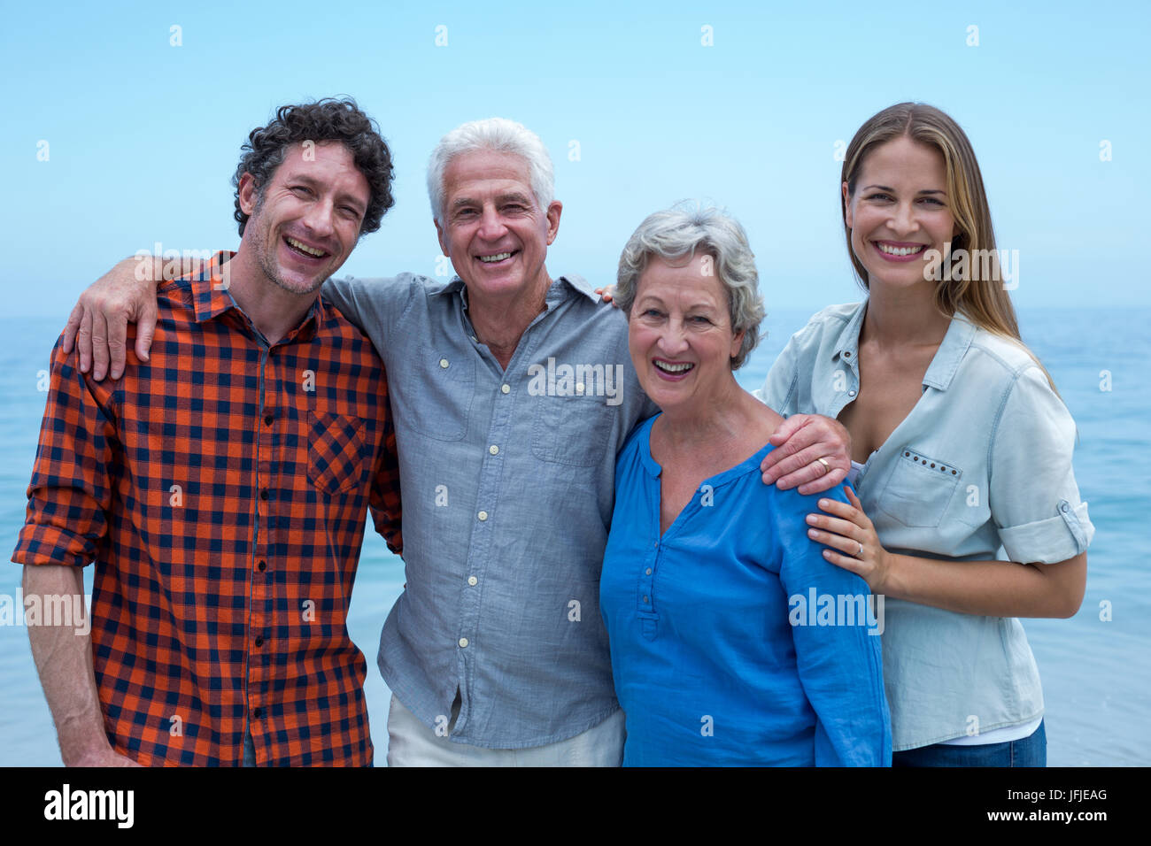 Fröhliche Familie Meer gegen blauen Himmel Stockfoto