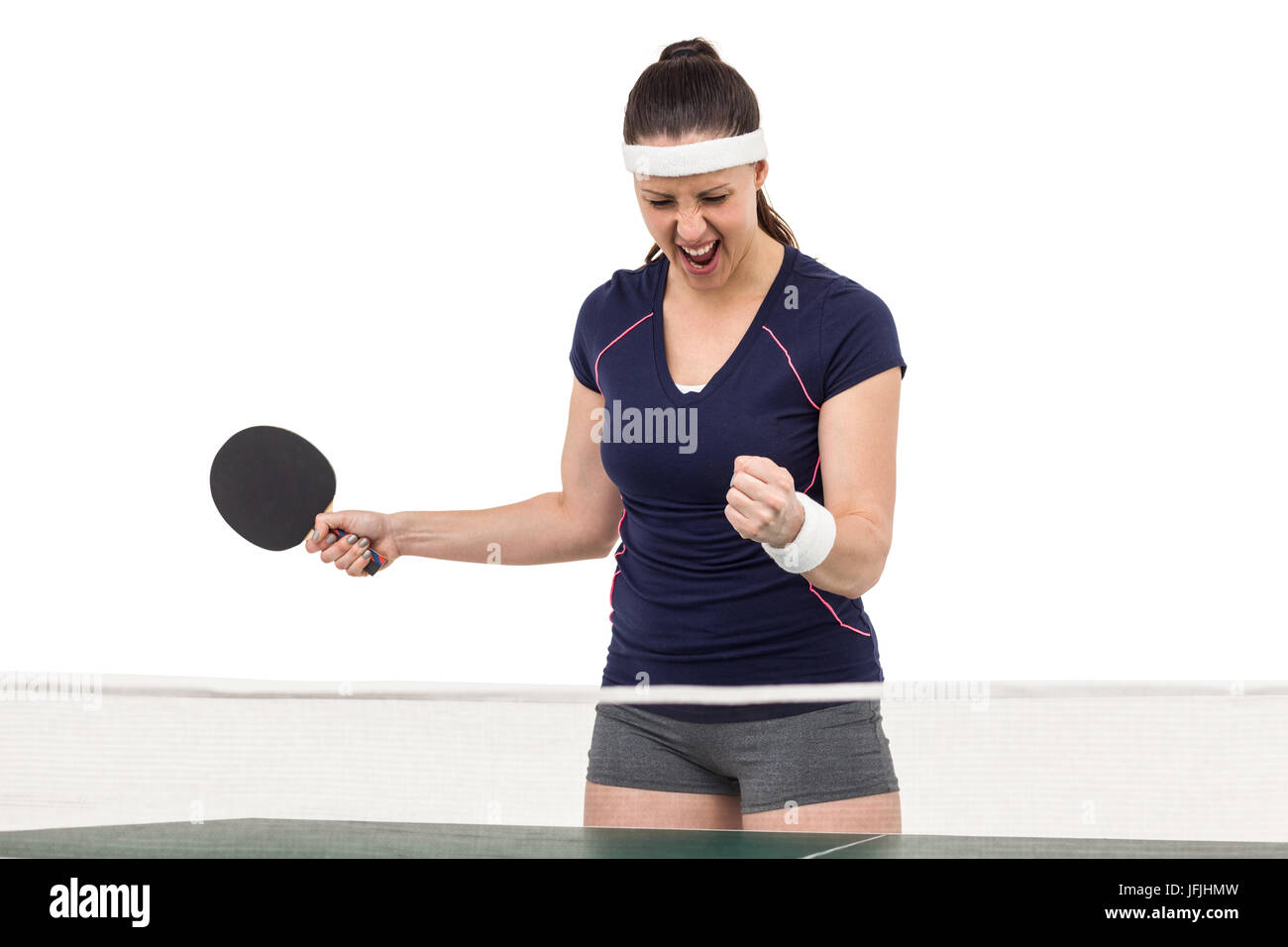 Weibliche Tischtennisspieler posiert nach Sieg Stockfoto