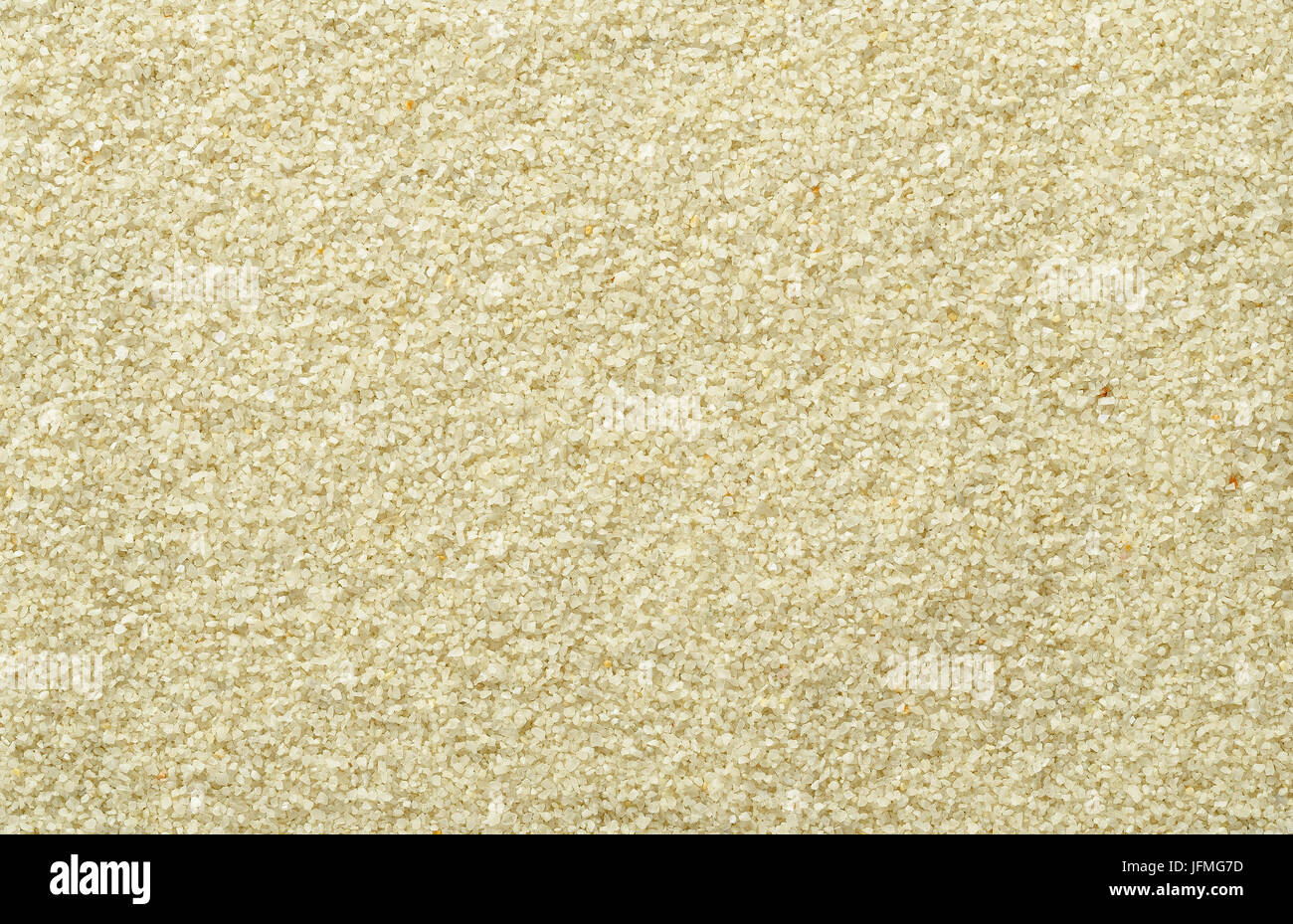 Oberfläche glatt und auch Sand. Hell braun und Ocker gefärbt Sandkörner. Hintergründe. Nahaufnahme Makro-Aufnahme direkt von oben. Stockfoto