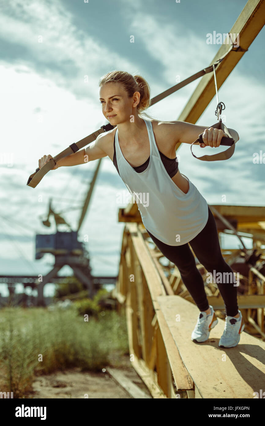 Frau dabei Oberkörper Übung Training Arme mit Trx suspension Stockfoto