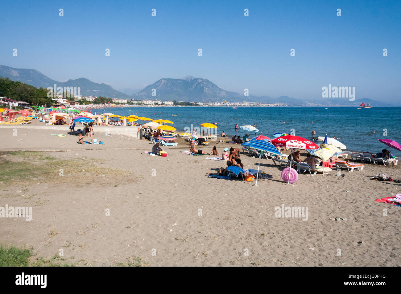 Menschen genießen die Sonne am Strand von Alanya, Türkei Stockfoto