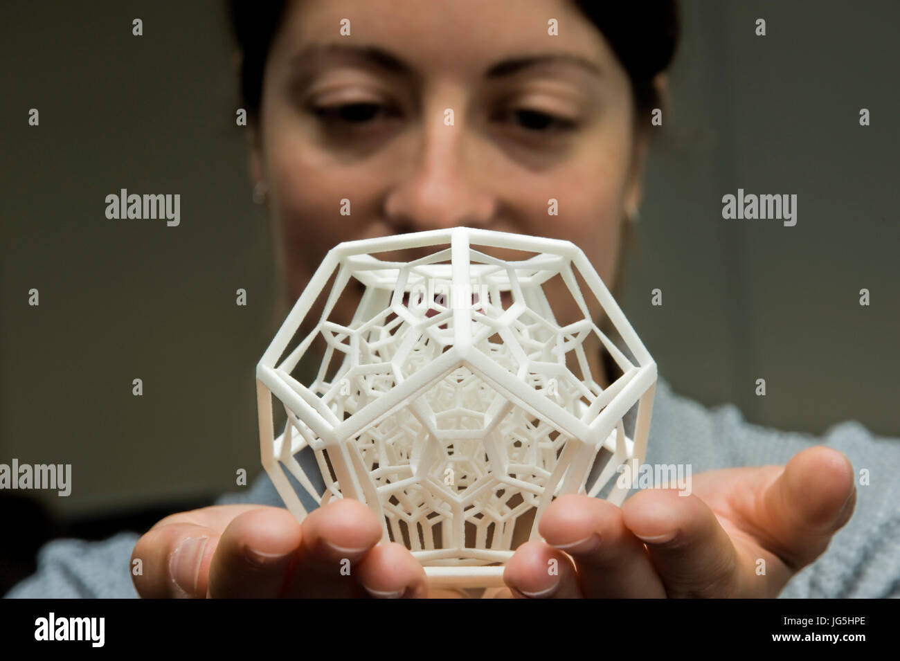 Frau hält Komplexes 3-dimensionale Objekt produziert durch selektives Laser Sintern (SLS). Stockfoto