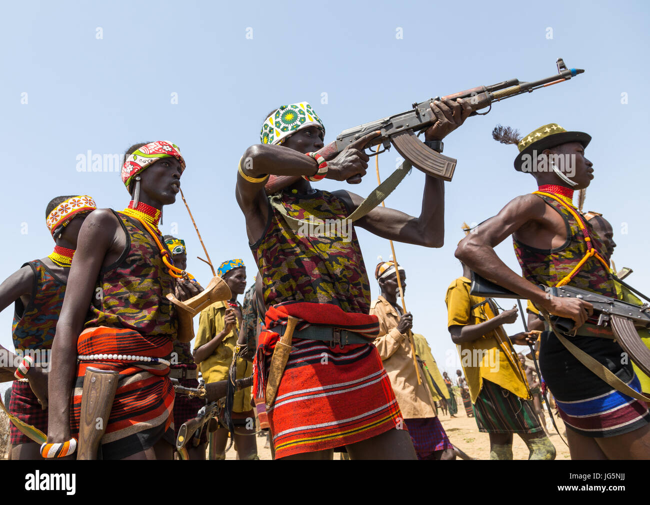 Mann mit einer Kalaschnikow schießen, während der Zeremonie stolz Ochsen in den Dassanech Stamm, Turkana County, Omorate, Äthiopien Stockfoto