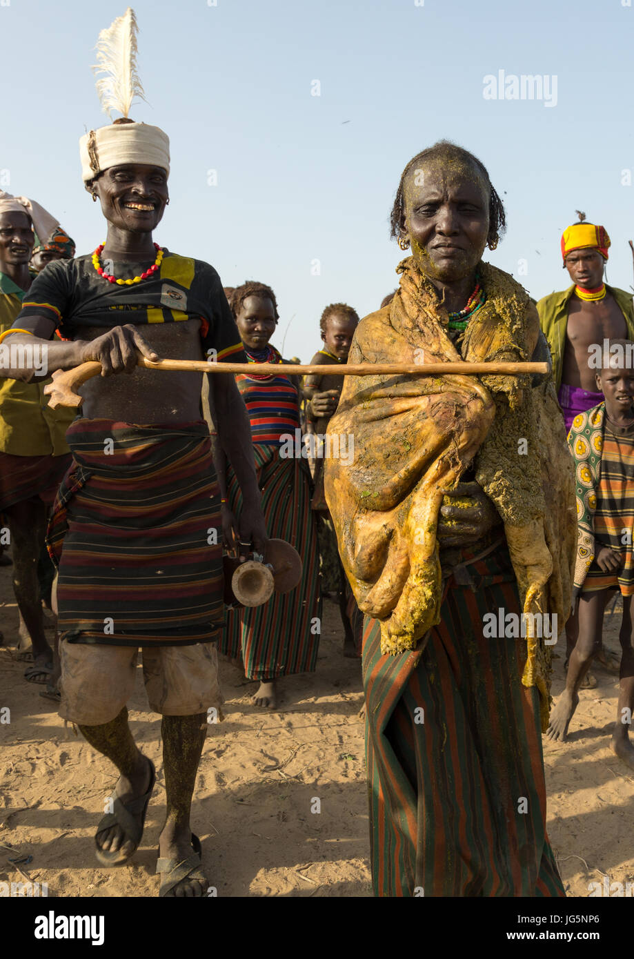 Alte Frau deckt sich mit dem Magen einer Kuh während der Zeremonie stolz Ochsen in den Dassanech Stamm, Turkana County, Omorate, Äthiopien Stockfoto