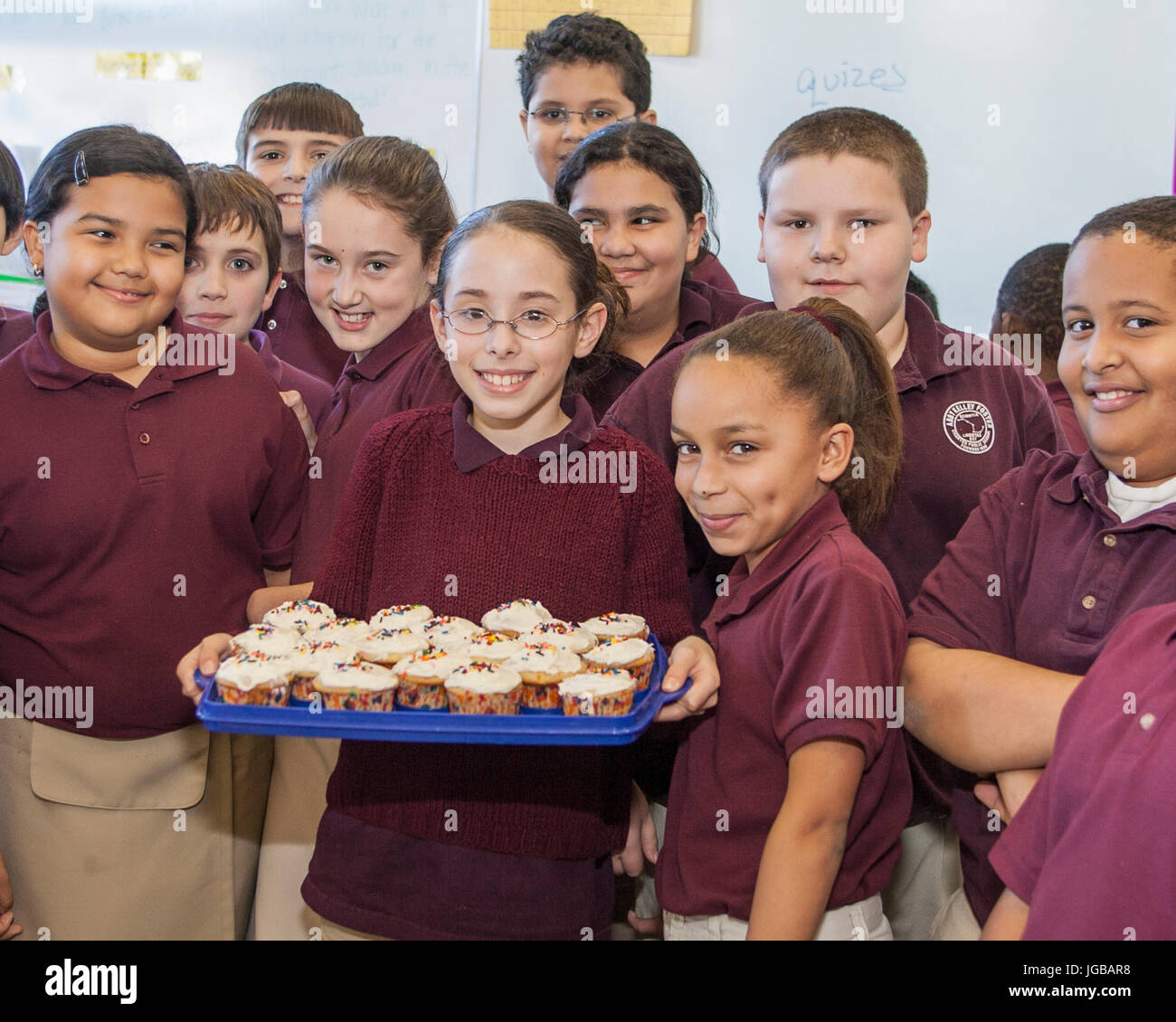 Grundschule Kinder genießen einige frische Muffins Stockfoto