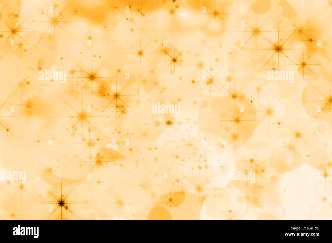Ein Hintergrund der gelben Farbtöne von Bokeh Effekte komponiert und mit Sternen übersät. Stockfoto