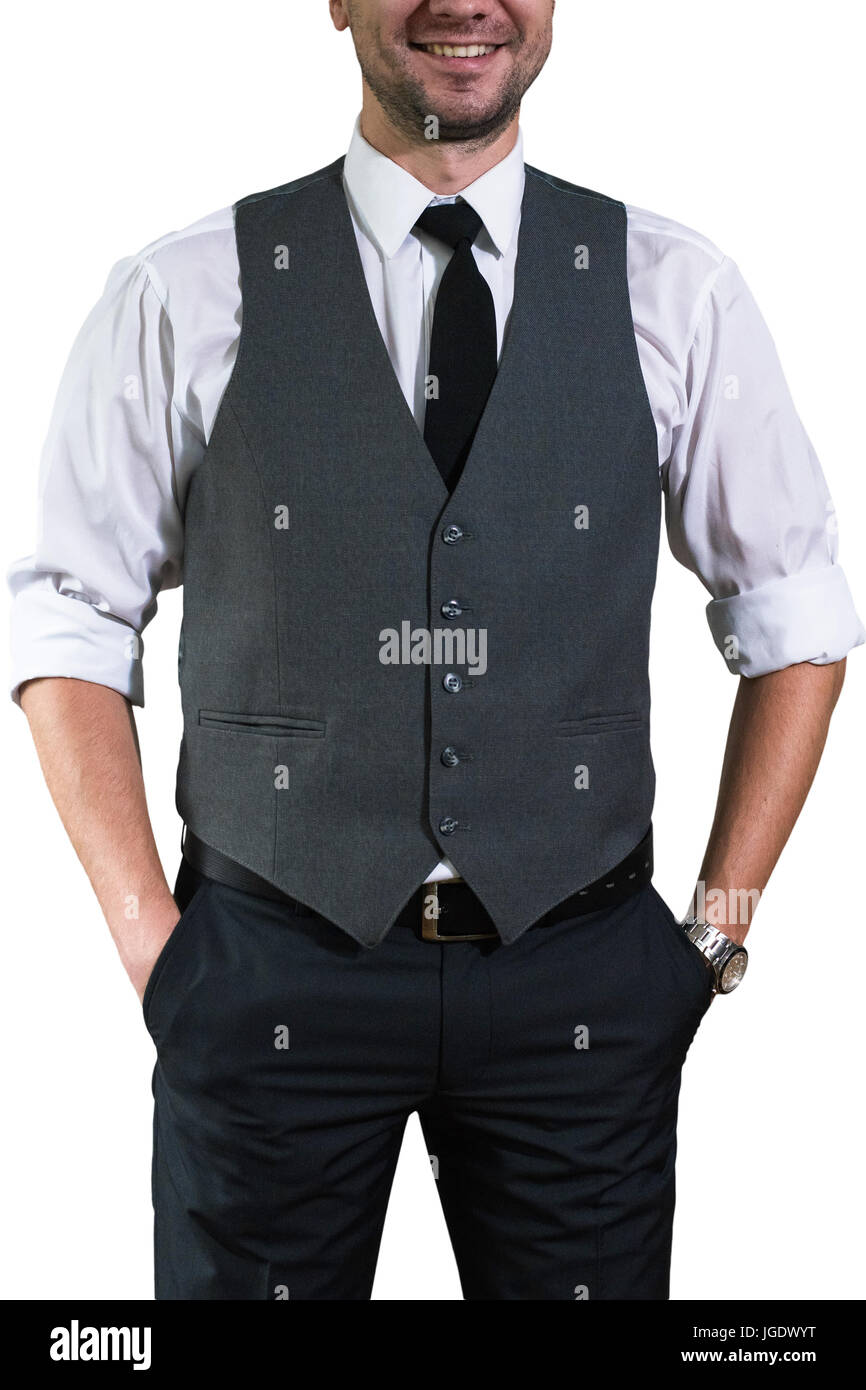 Ein junger Geschäftsmann in einem weißen Hemd mit aufgerollten Ärmeln steht und hält seine Hände in die Taschen der Hose. Hopster Kerl in einem stilvollen grau w Stockfoto