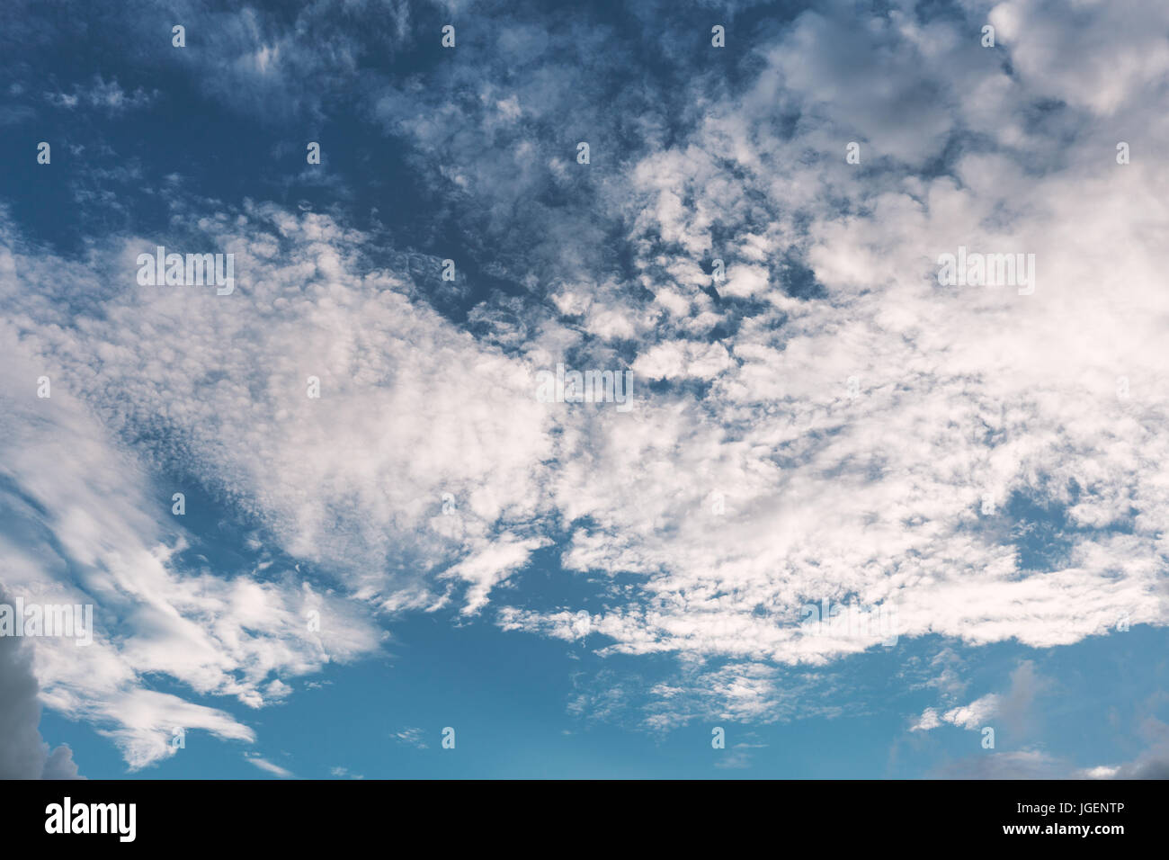 Leicht Wolken schweben auf abgestuften blauen Himmel mit Sonnenlicht Stockfoto