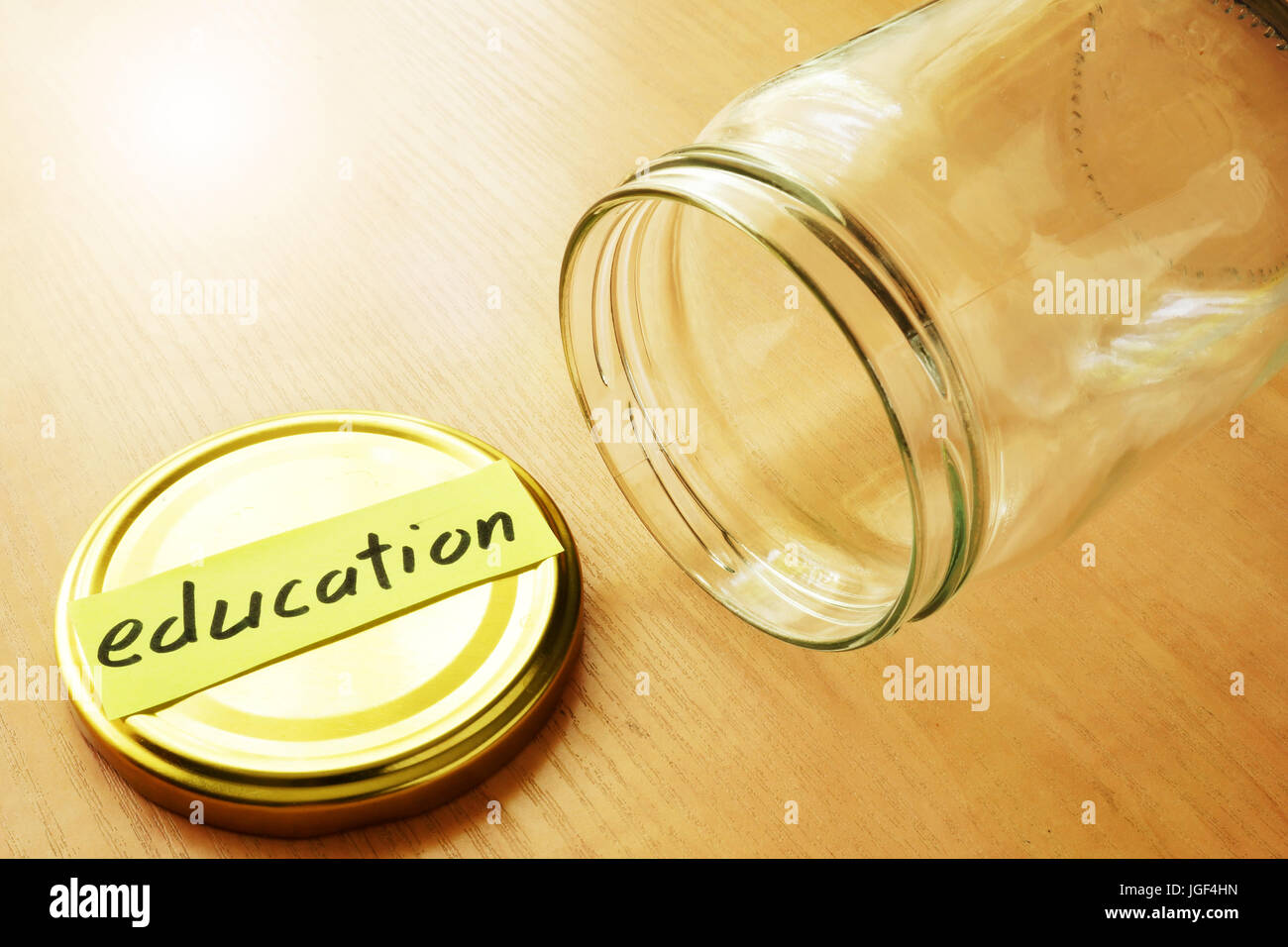 Leeres Glas mit Label-Bildung. Einsparungen für College-Konzept. Stockfoto