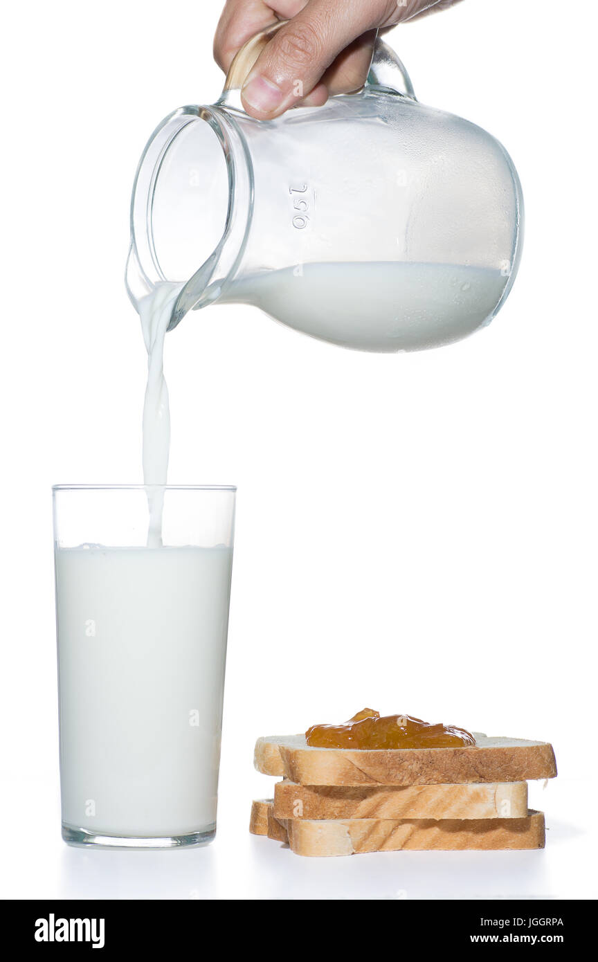 Milch dienen in ein Glas mit Brot und Marmelade auf weißem Hintergrund Stockfoto