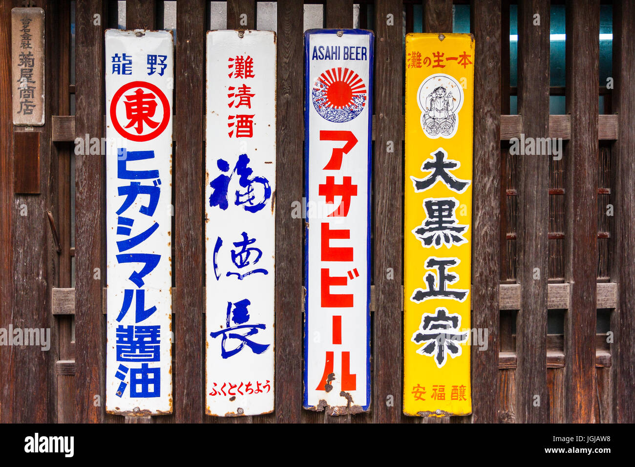 Japan, Tatsuno. Traditionelle altmodische japanische Kanji länglich Anzeige Anzeichen für Bier und Saki an der vorderen Abschnitte der alten Japanischen style Store. Stockfoto