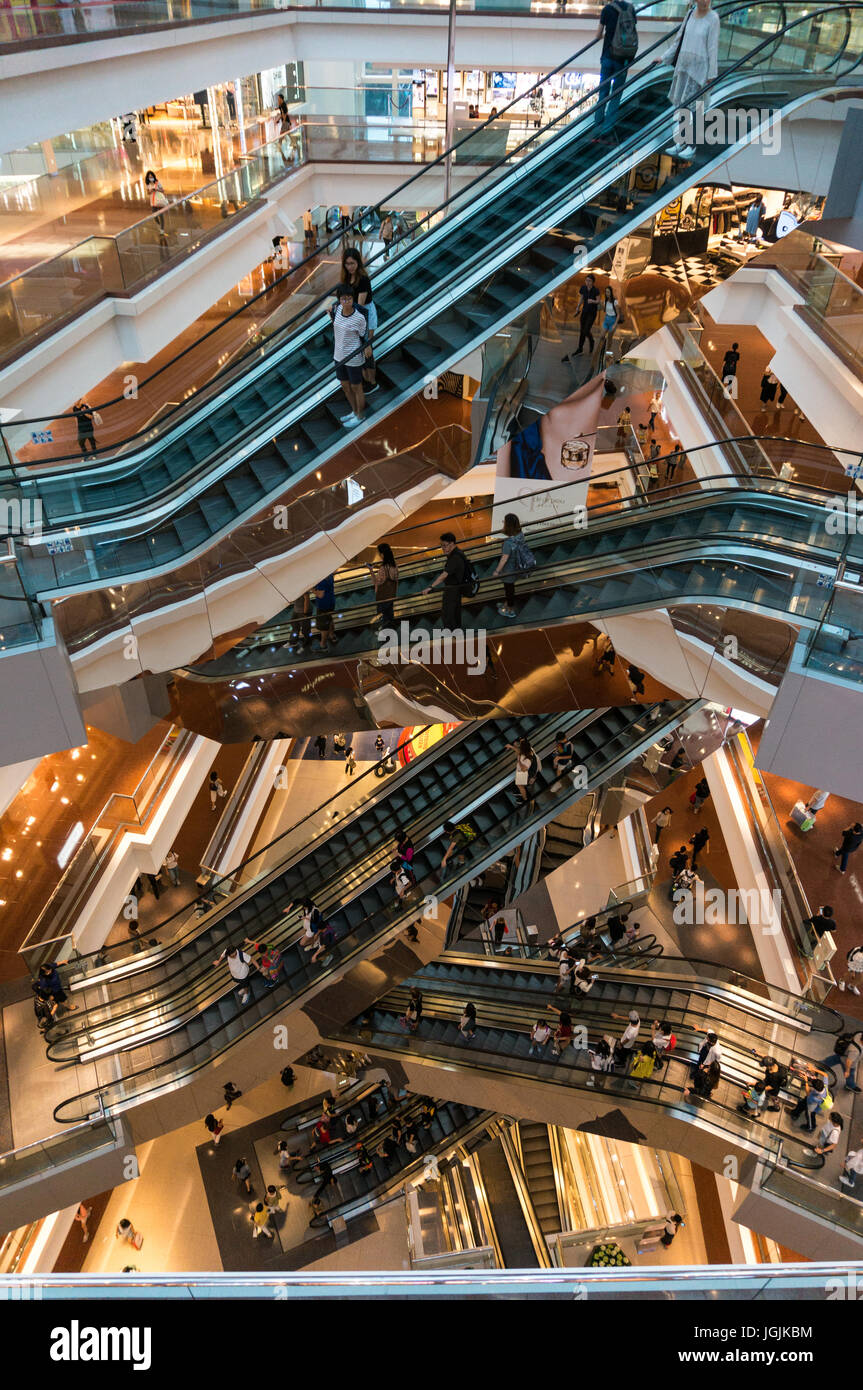 Rolltreppen und Shopper in einem Einkaufszentrum in Hong Kong SAR Stockfoto