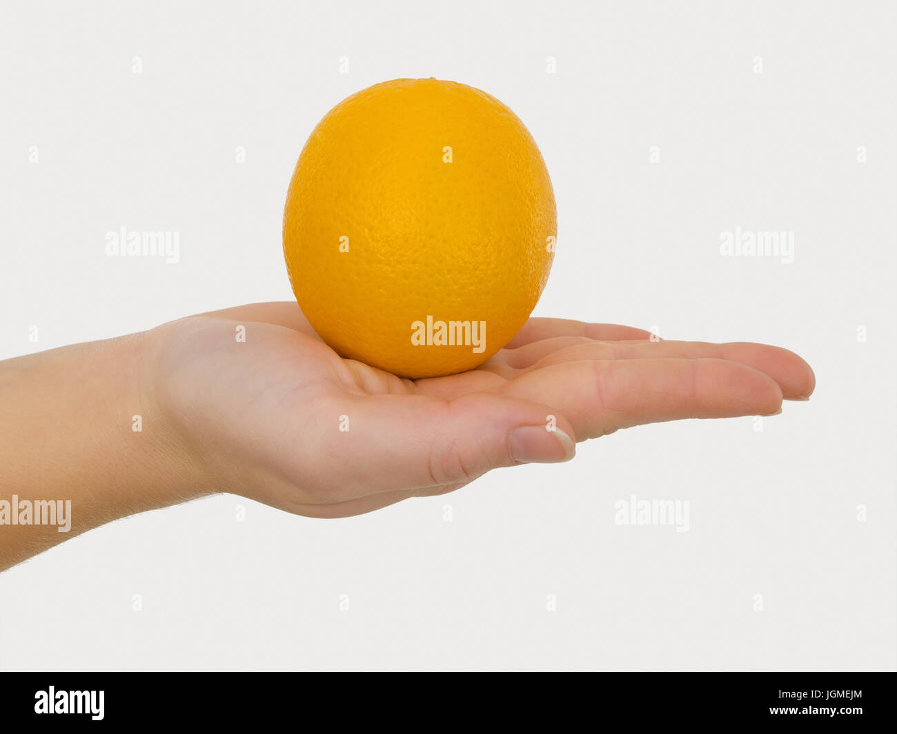 Orange in der Hand - Orange in einer Hand, Orange in der Hand - orange in einer hand Stockfoto