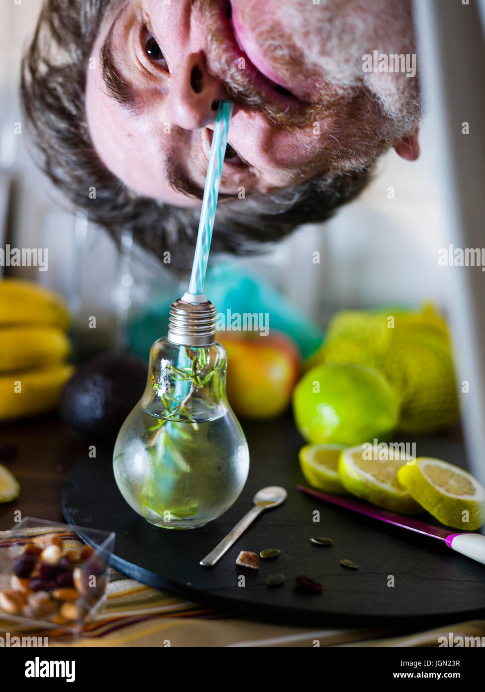 Kleine Design-Glas mit Stroh gefüllt mit infundierten Wasser Zitrone, Stroh. Frisch, Sommerlaune. Stockfoto