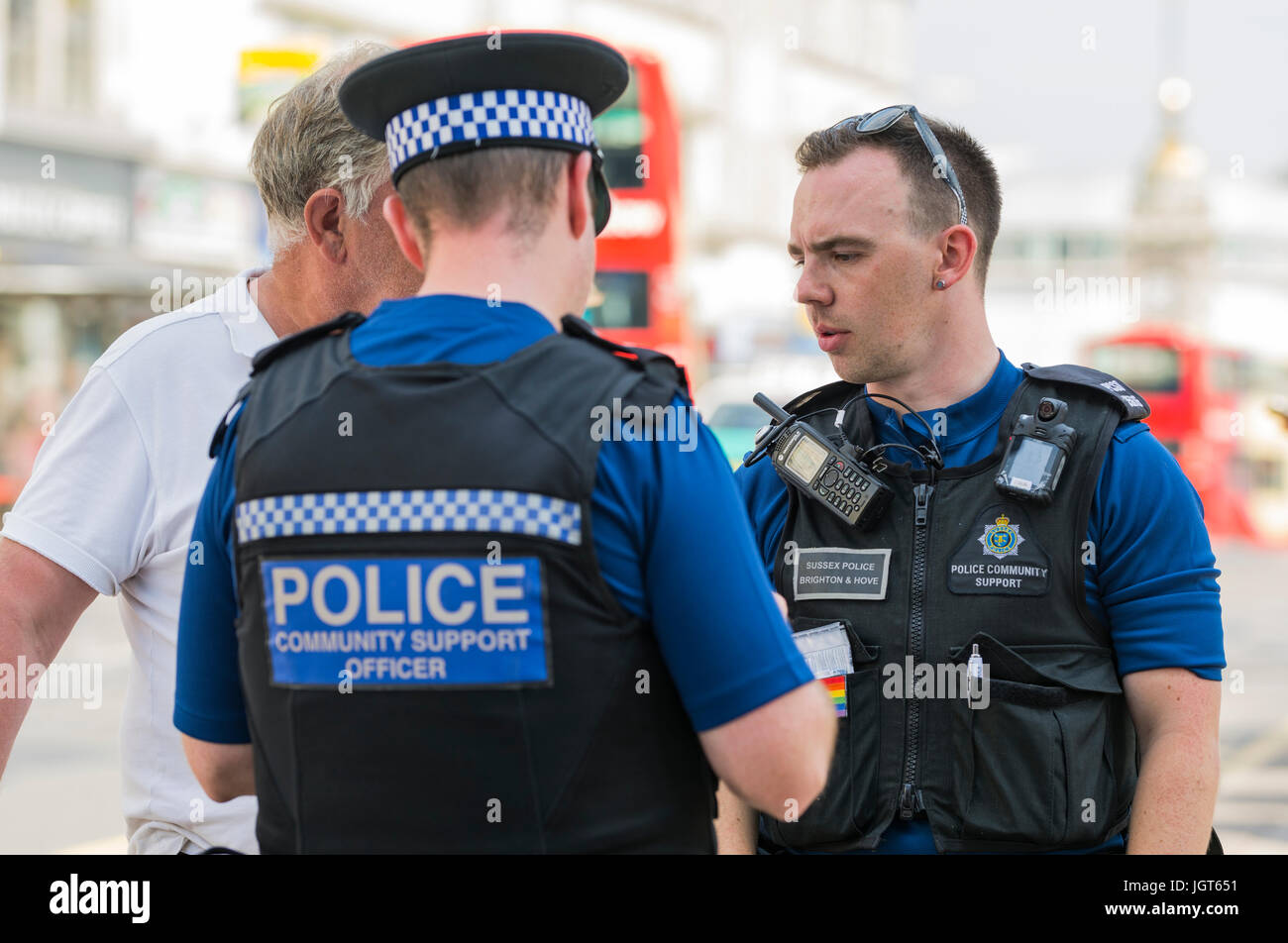 PCSOs (Police Community Support Officers) im Gespräch mit jemand auf den Straßen von Brighton, East Sussex, England, UK. Stockfoto