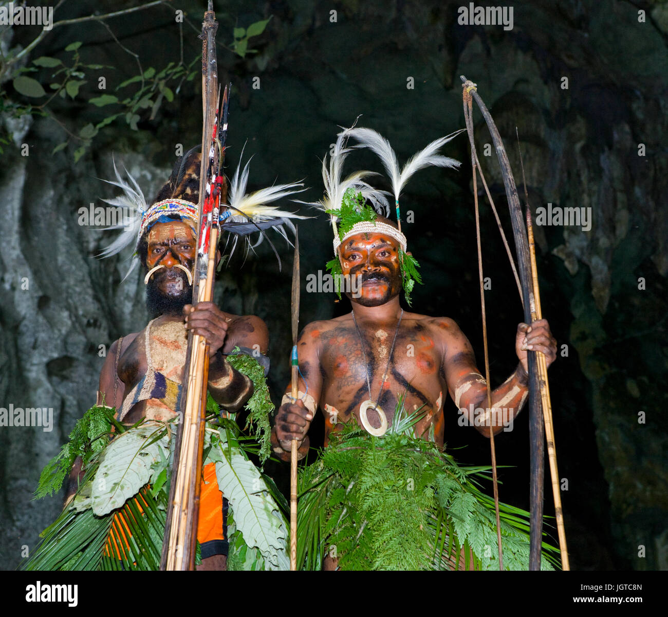 Neuguinea, Indonesien - 13 Januar: Krieger Stamm Yaffi in Kriegsbemalung mit Pfeil und Bogen in der Höhle. Neue Insel Guinea, Indonesien. Stockfoto