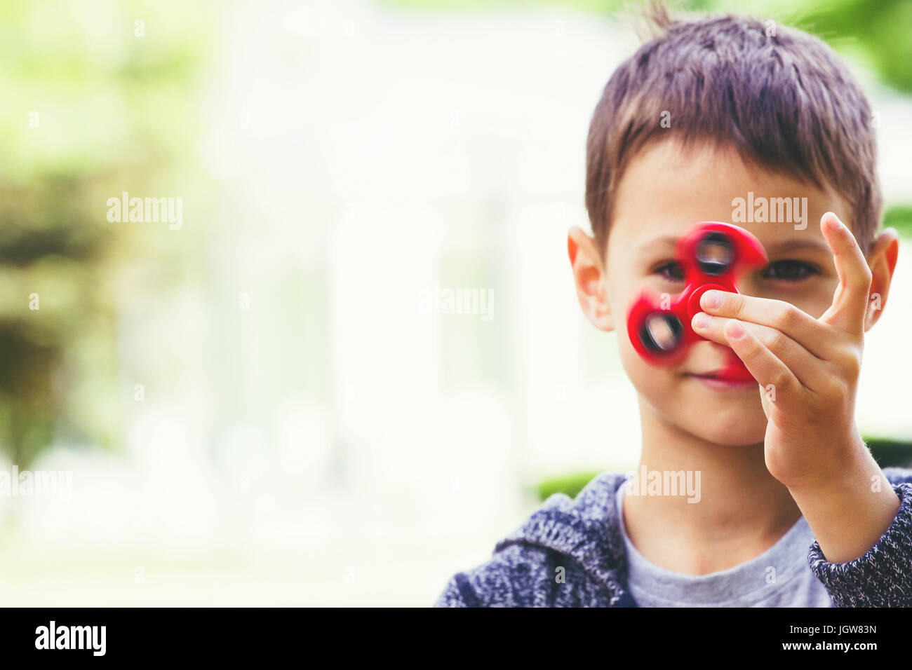 Junge mit einem Fidget Spinner im freien Stockfoto