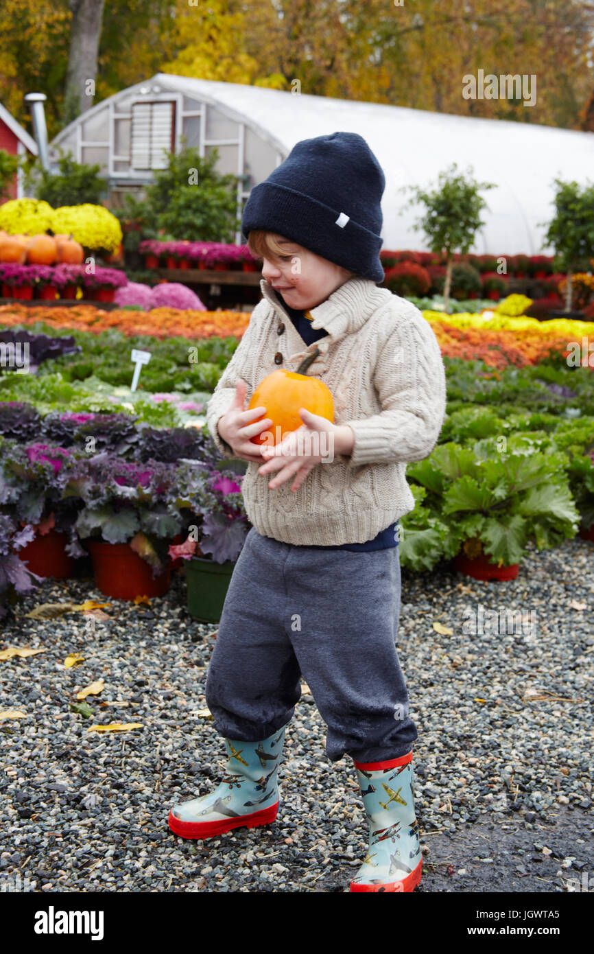 Junge mit Kürbis im Garten-Center Stockfoto