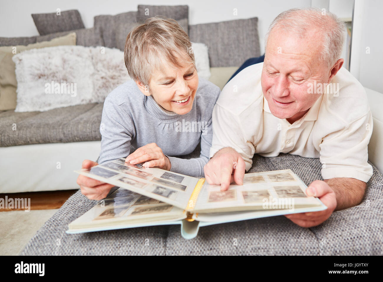 Senioren mit Fotoalbum betrachten von Fotos als Erinnerung Stockfoto