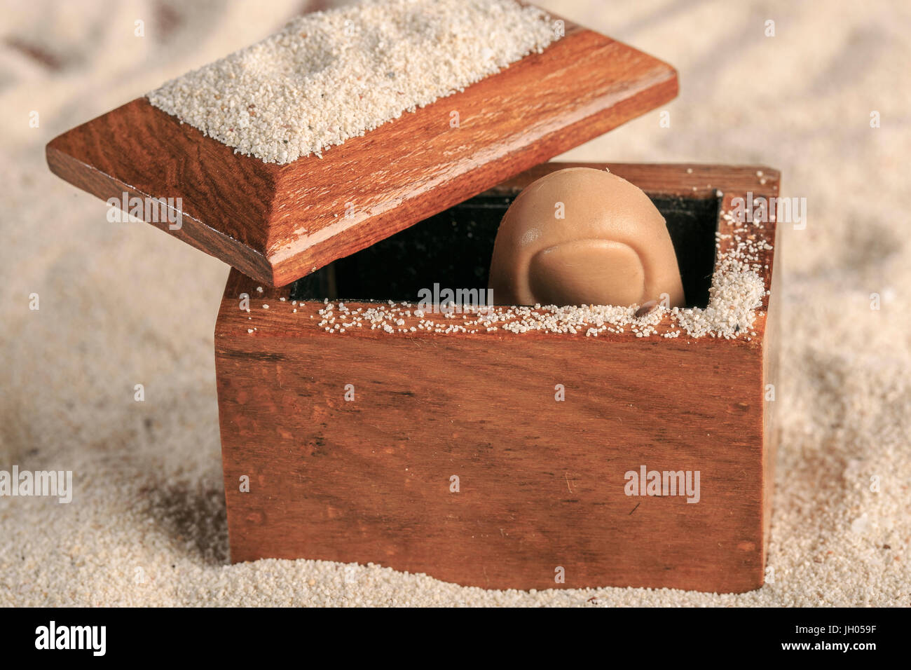 Hölzerne Truhe öffnete am Sandstrand Stockfoto